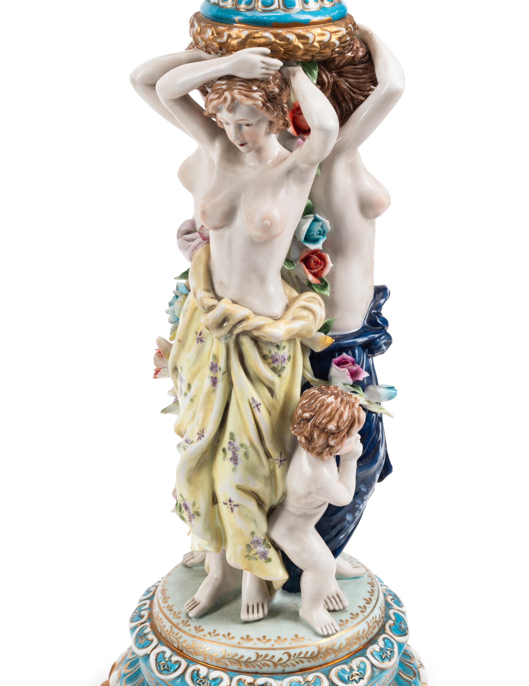 A Pair of Gilt Metal and Porcelain Figural Four-Light Candelabra