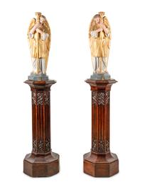 A Pair of Painted and Parcel Gilt Figural Altar Prickets with Associated Gothic Revival Pedestals