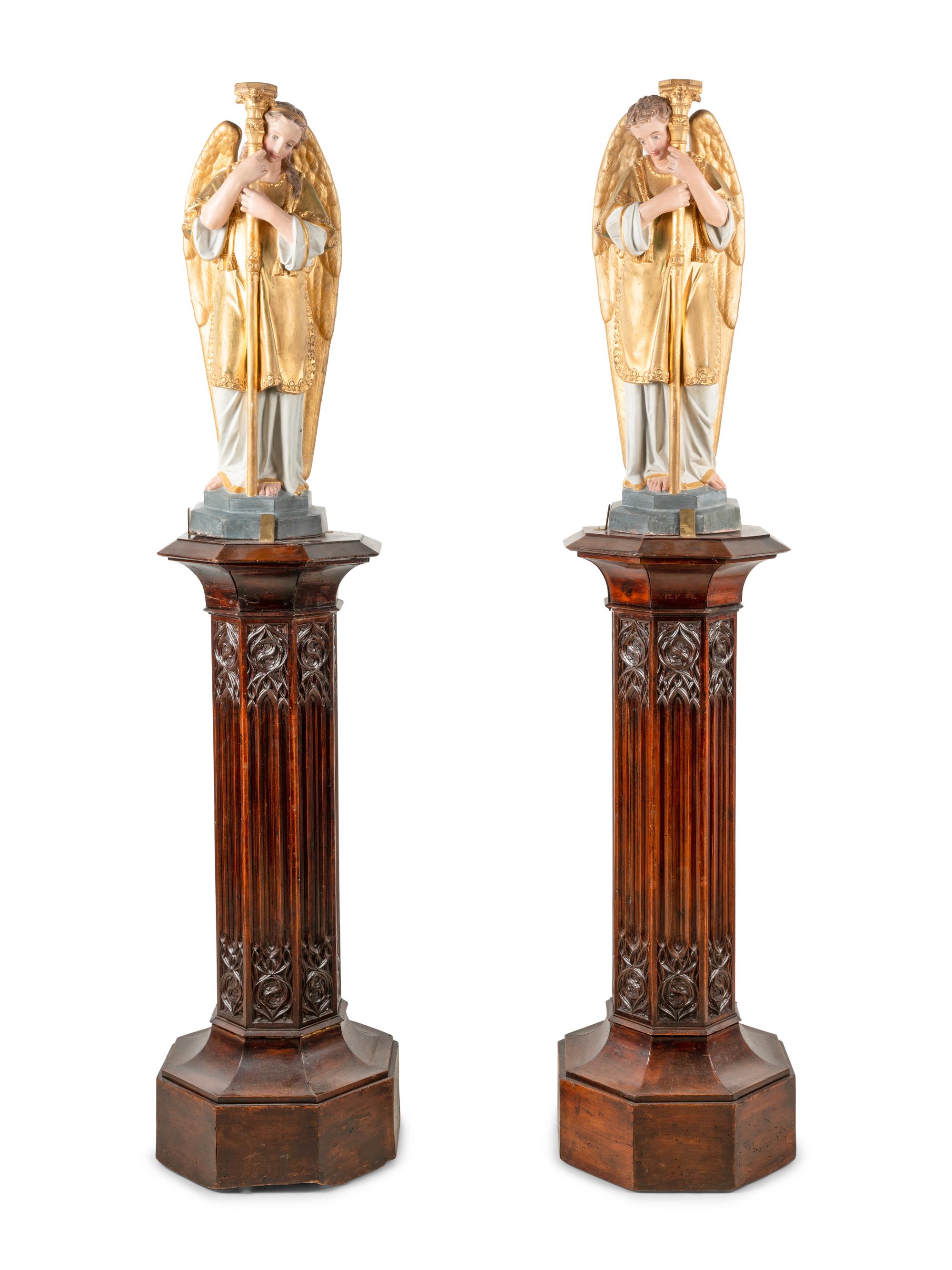A Pair of Painted and Parcel Gilt Figural Altar Prickets with Associated Gothic Revival Pedestals