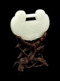 A White Jade Lock-Form Pendant with Stand