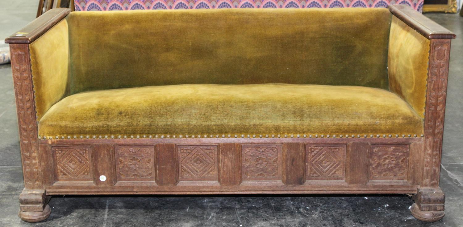 An Arts and Craft Oak Settle. Width 69 inches.