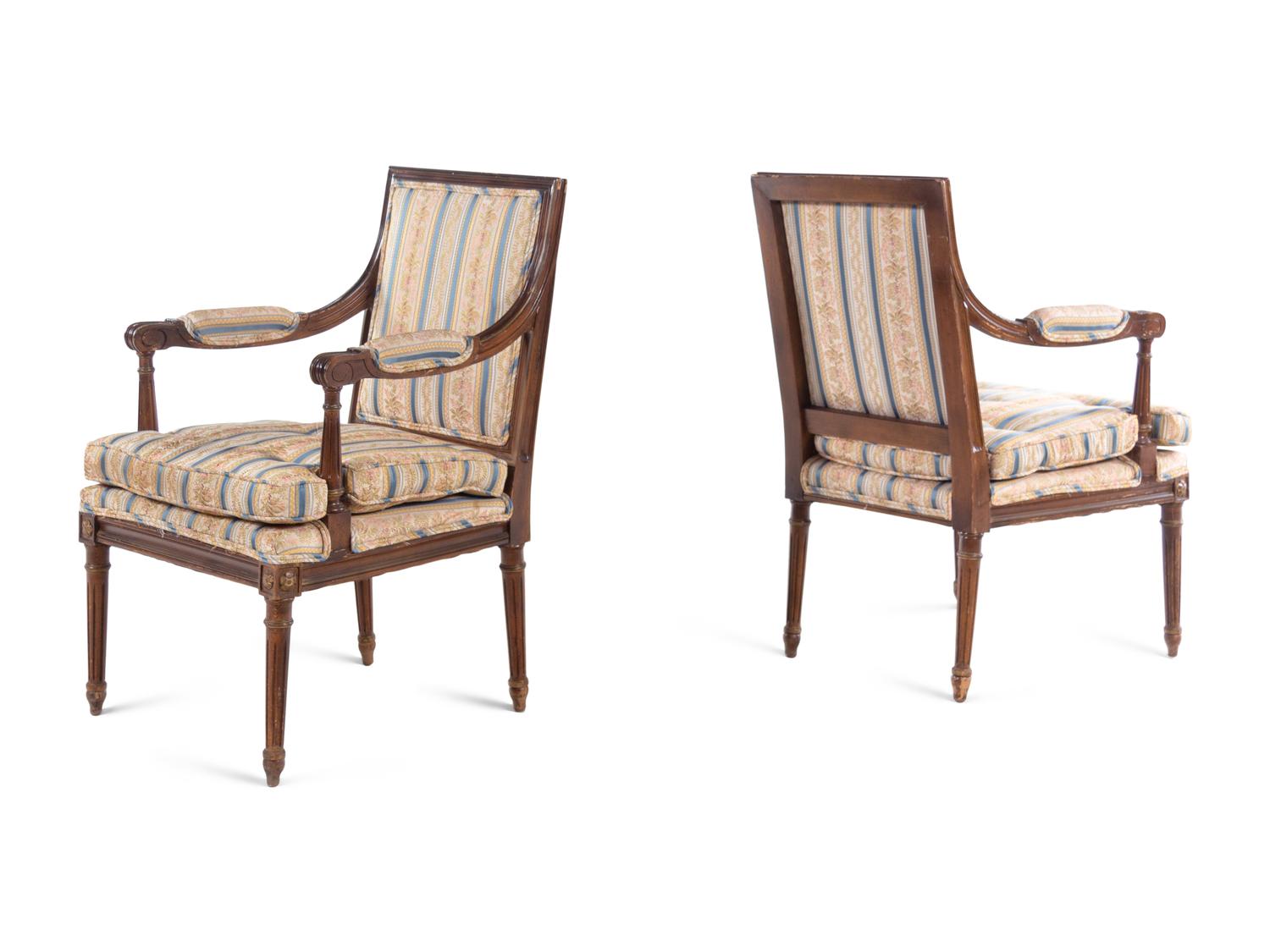 A Pair of Louis XVI Style Walnut Fauteuils