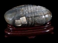 A Grey and Russet Jade Purse-Form Paperweight