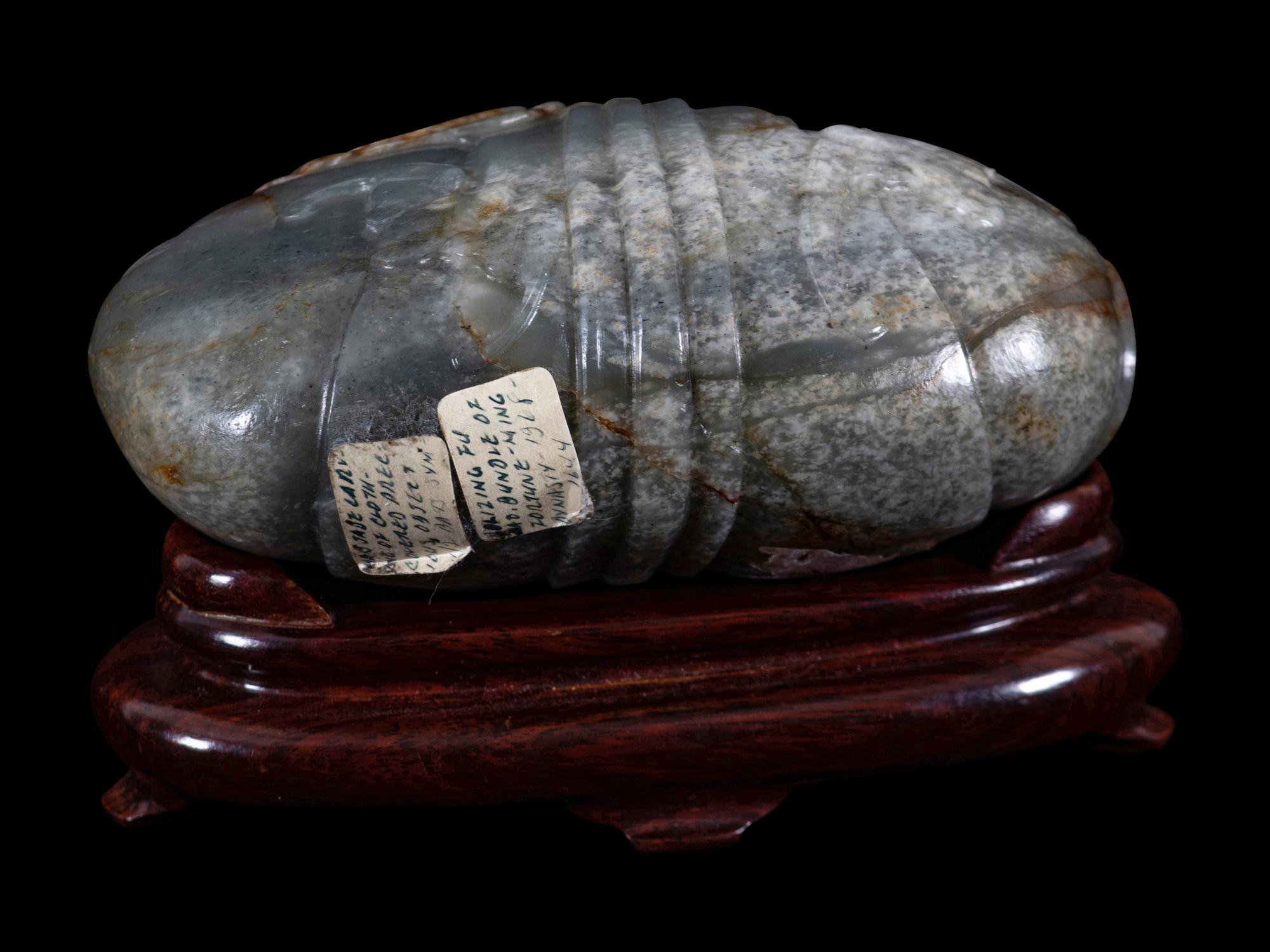A Grey and Russet Jade Purse-Form Paperweight