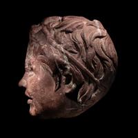 A Roman Rosso Antico Head of a Young Satyr