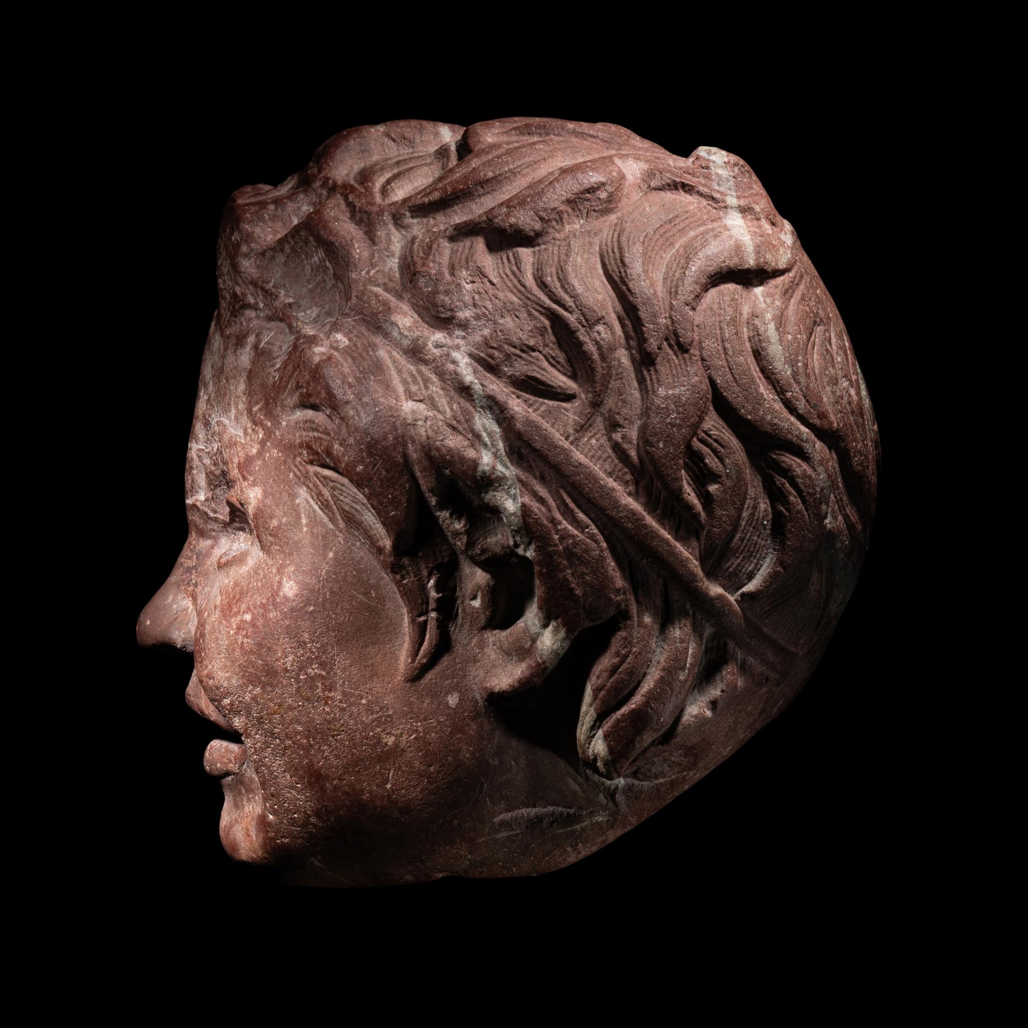 A Roman Rosso Antico Head of a Young Satyr