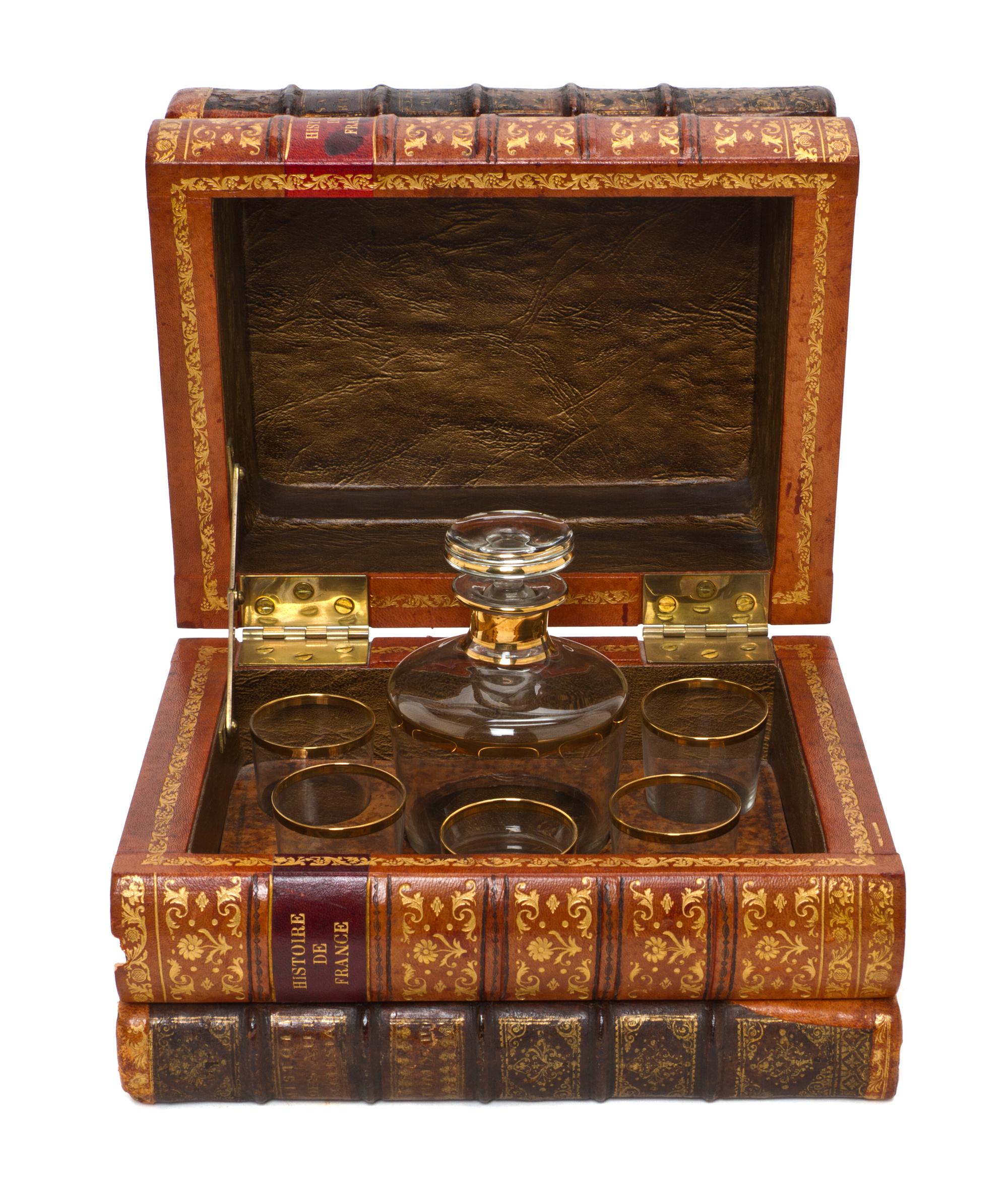 A French Book Form Decanter Set, Height 7 1/2 x width 10 1/8 x depth 8 inches.