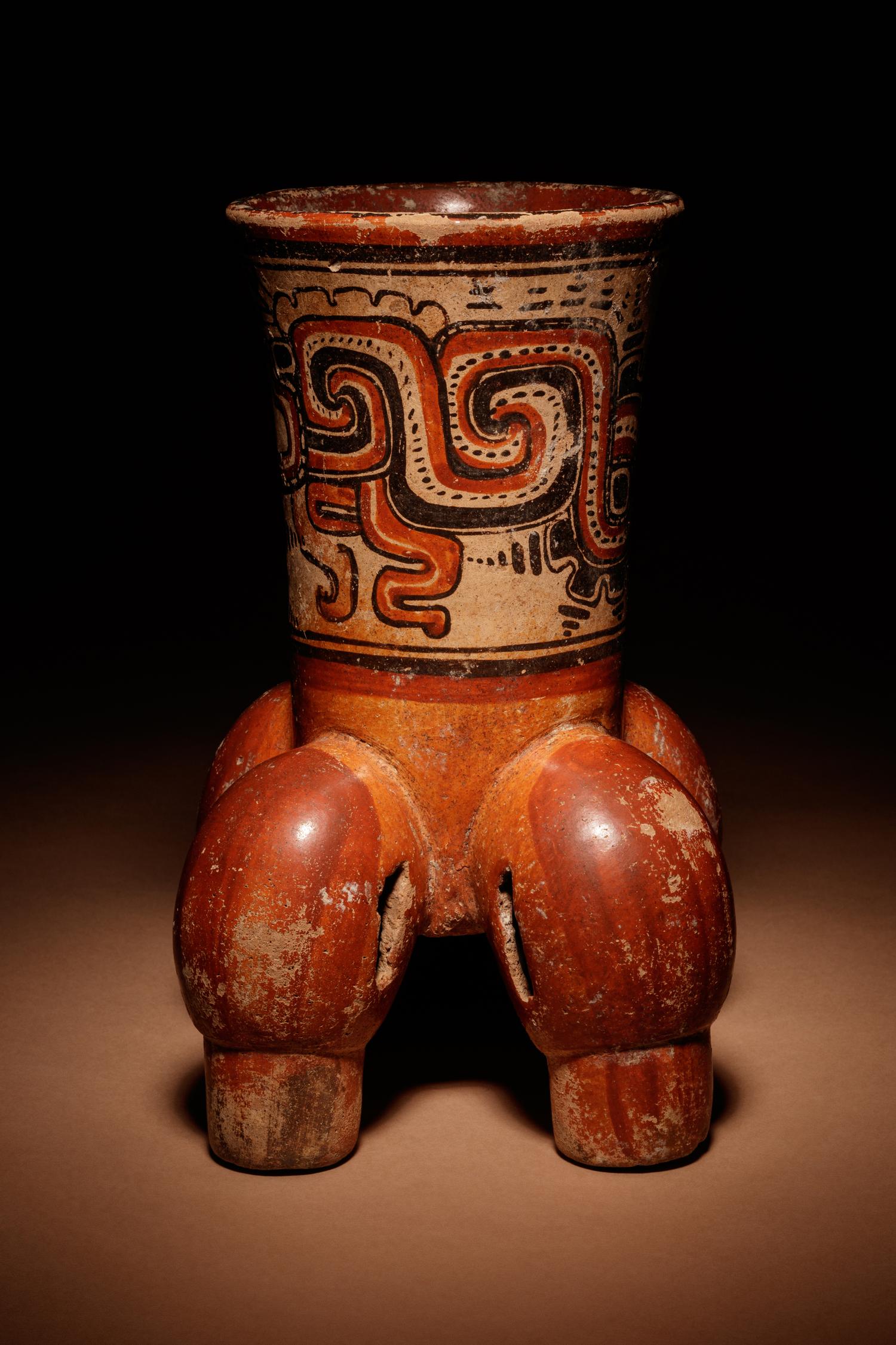 A Maya Polychrome Vessel with Rattle Feet