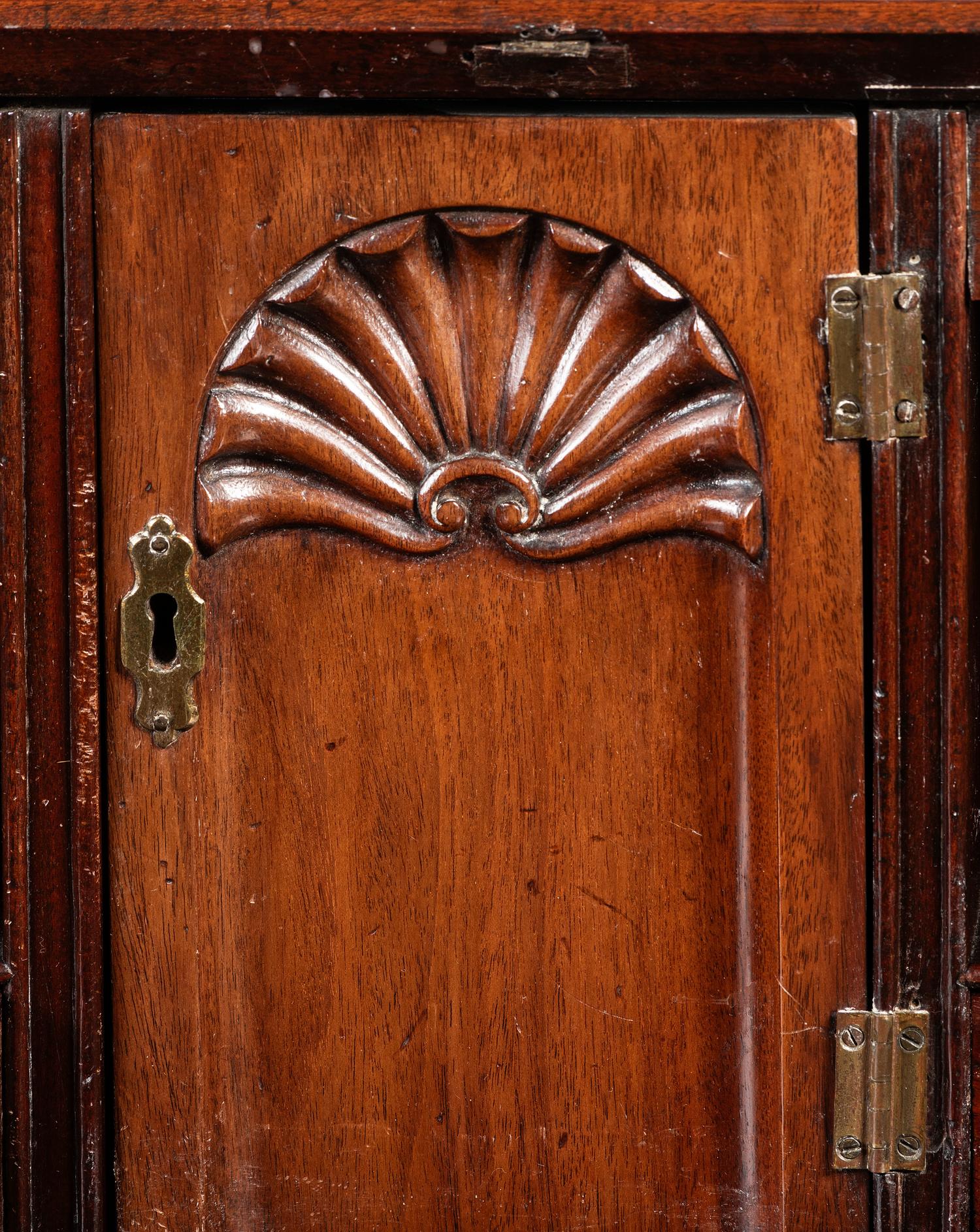 A Chippendale Figured and Shell-Carved Mahogany Slant Front Desk
