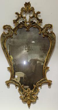 A Rococo Style Cartouche Form Mirror. Height 46 1/2 x width 25 1/4 inches.