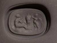 A Roman Carnelian Ring Stone with the God Eros Beside a Tropaion — Set in a gilt-copper ring