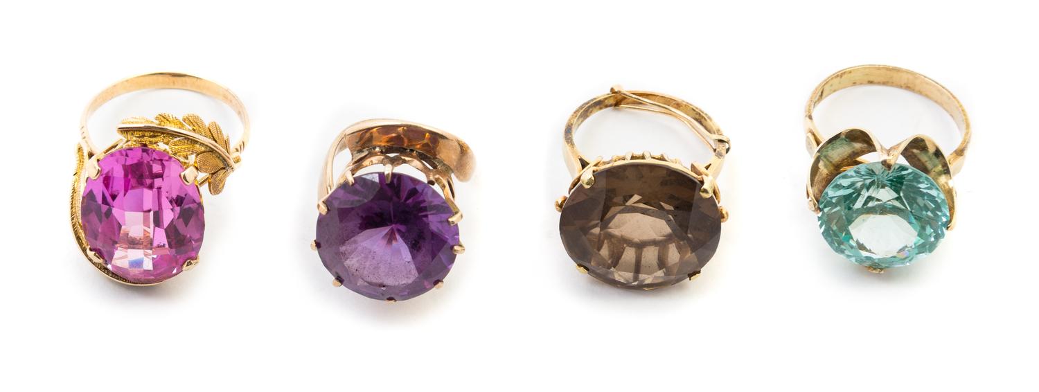 a Collection of 14 Karat Yellow Gold and Synthetic Gemstone, Glass and Smokey Quartz Rings, 23.10 dwts.