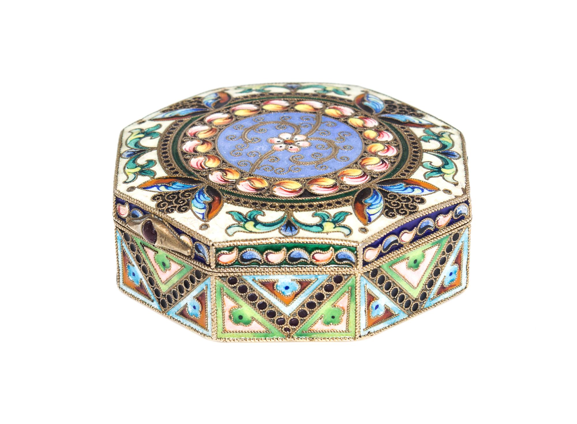 A Russian Enameled Gilt-Silver Pill Box, 11th Artel, Moscow, 1908-1926, of octagonal form with polychrome floral decoration.
