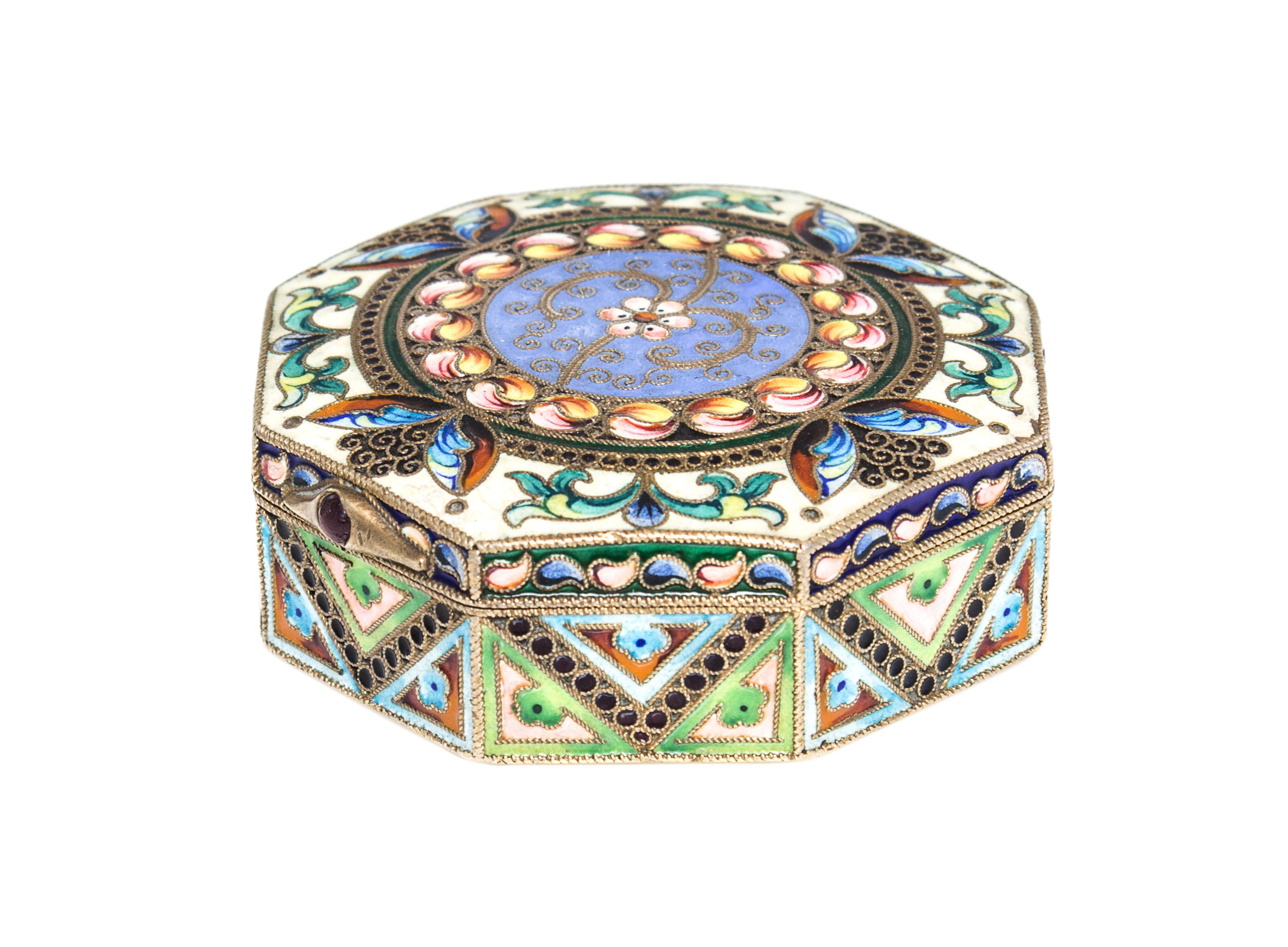 A Russian Enameled Gilt-Silver Pill Box, 11th Artel, Moscow, 1908-1926, of octagonal form with polychrome floral decoration.