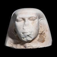 An Egyptian Limestone Canopic Jar Lid