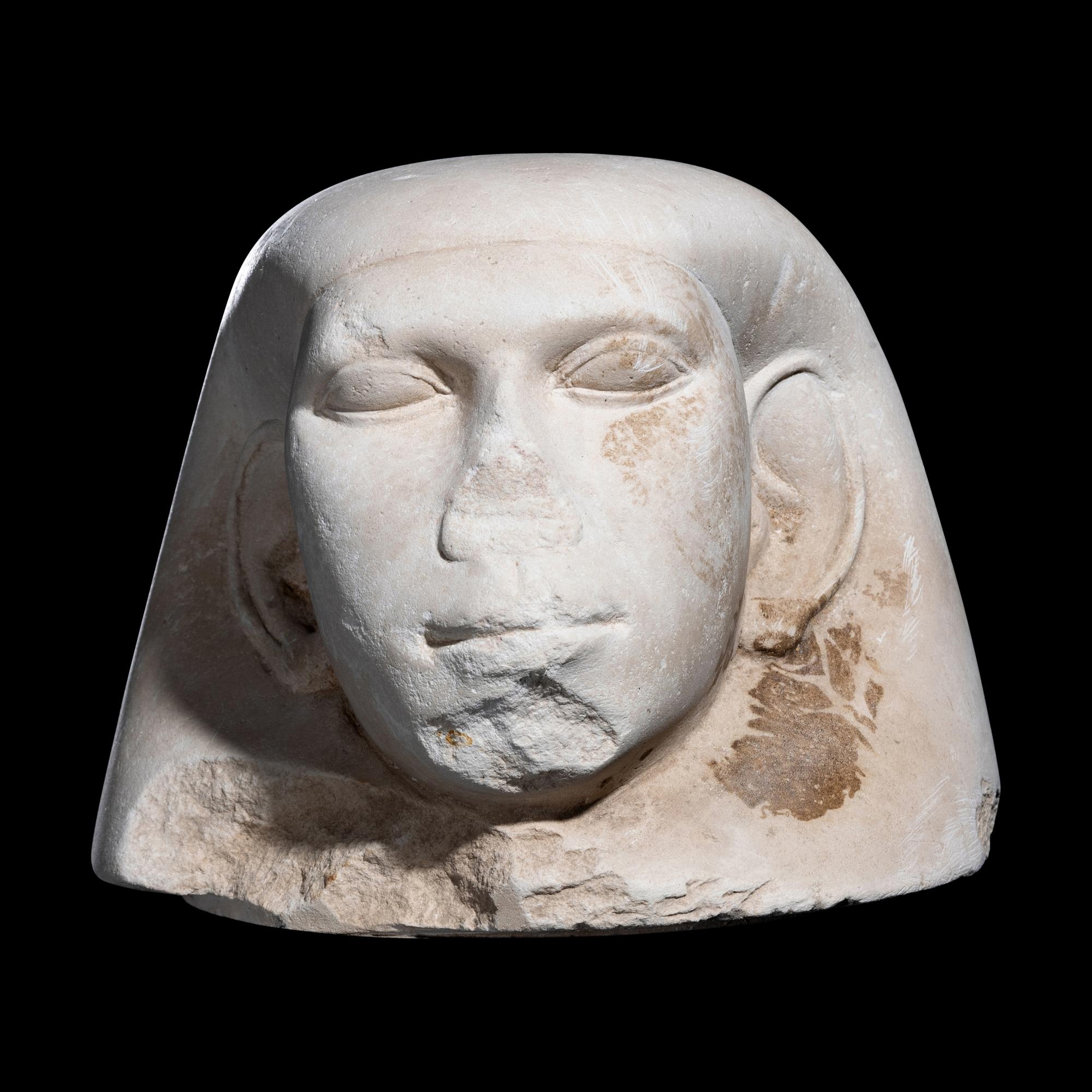 An Egyptian Limestone Canopic Jar Lid
