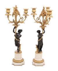 A Pair of Louis XVI Style Parcel Gilt and Bronze Three-Light Figural Candelabra