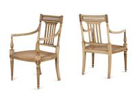 A Pair of Louis XVI Style Crème-Painted and Parcel-Gilt Fauteuils