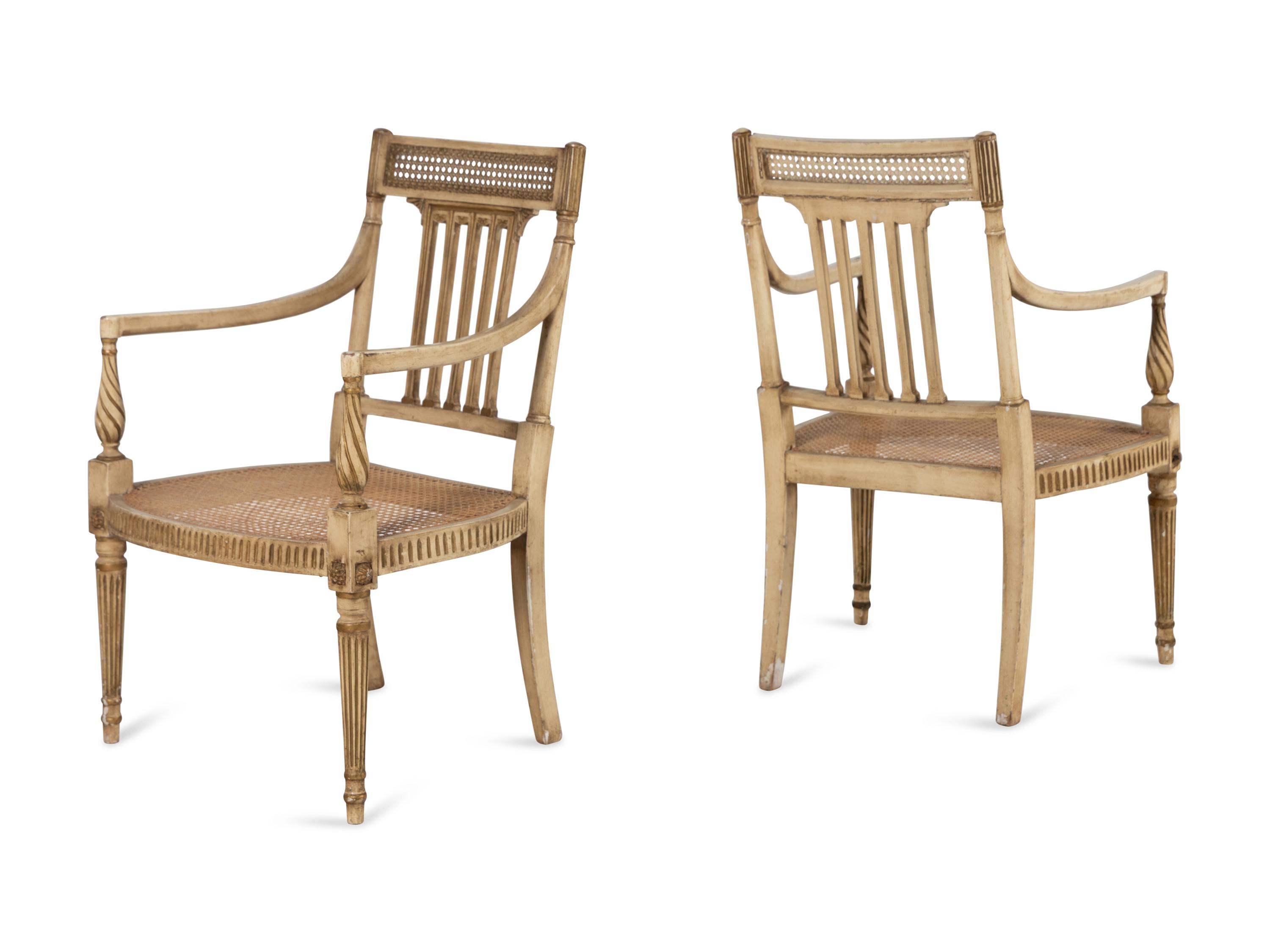 A Pair of Louis XVI Style Crème-Painted and Parcel-Gilt Fauteuils