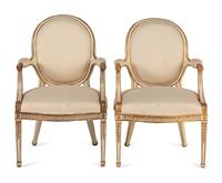 A Pair of Louis XVI Style Crème-Painted and Parcel Gilt Fauteuils