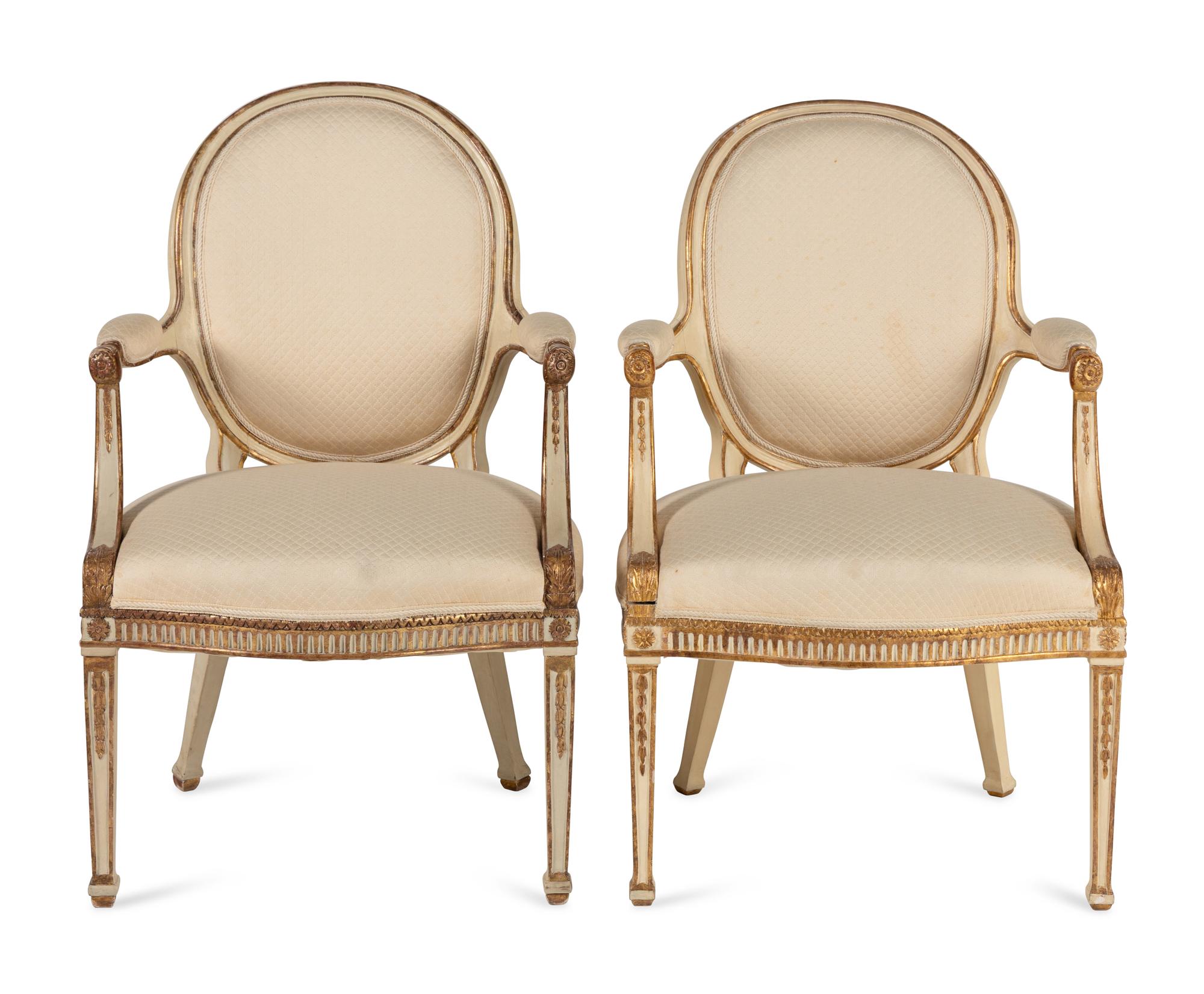 A Pair of Louis XVI Style Crème-Painted and Parcel Gilt Fauteuils