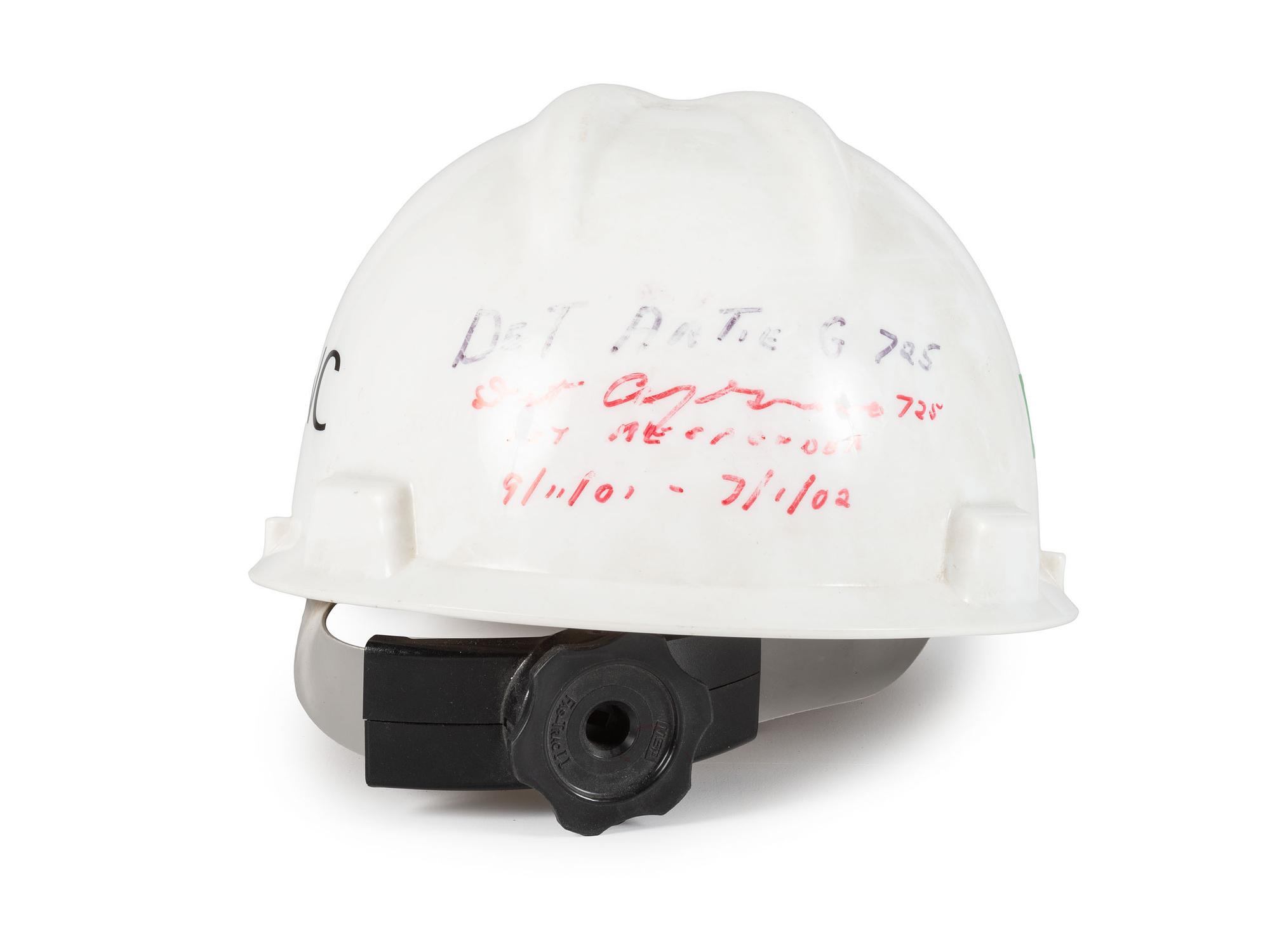 [FLAGS]. A group of items related to the recovery efforts at Ground Zero after September 11, 2011, incl. a helmet worn at the site by retired NYC Detective Arthur Giammarino as he assisted in the recovery efforts.