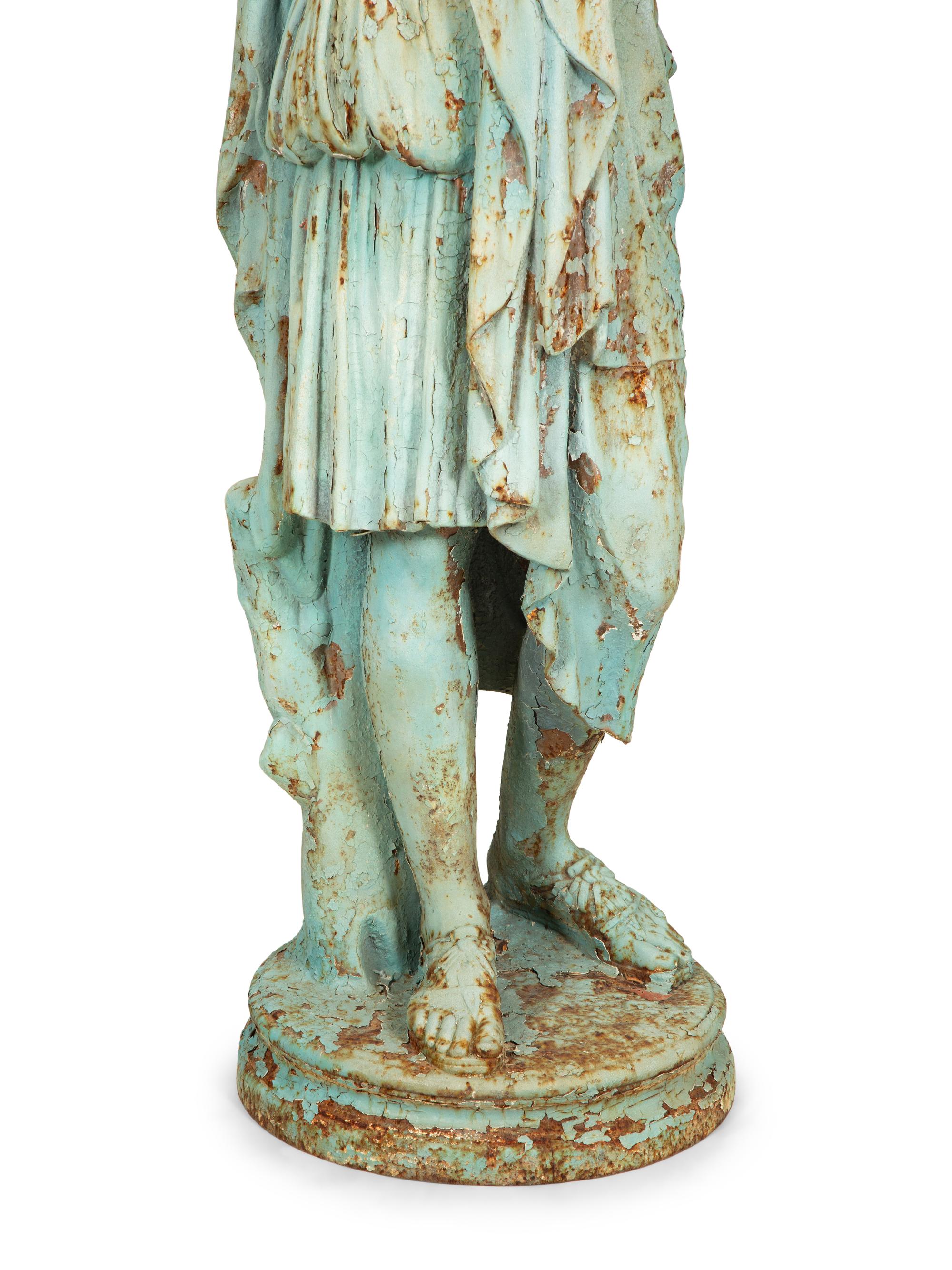 A Painted Cast Iron Diana of Gabii on a Carved Stone Base