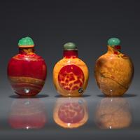 Three Chinese "Realgar" Glass Snuff Bottles, Qing Dynasty, 18th-19th Century — 清中期 雄黃料鼻煙壺三支
