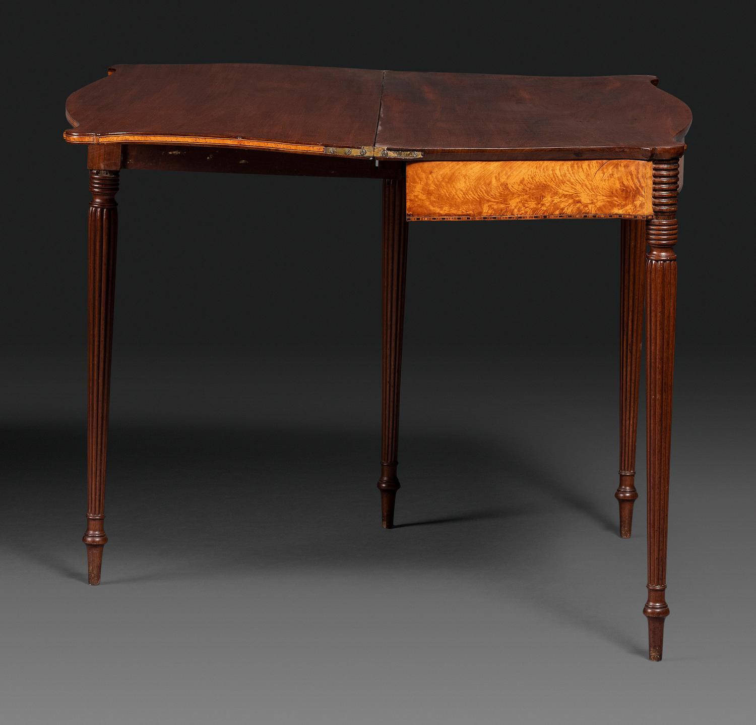 A Federal Birch Veneered and Inlaid Mahogany Serpentine-Top Games Table