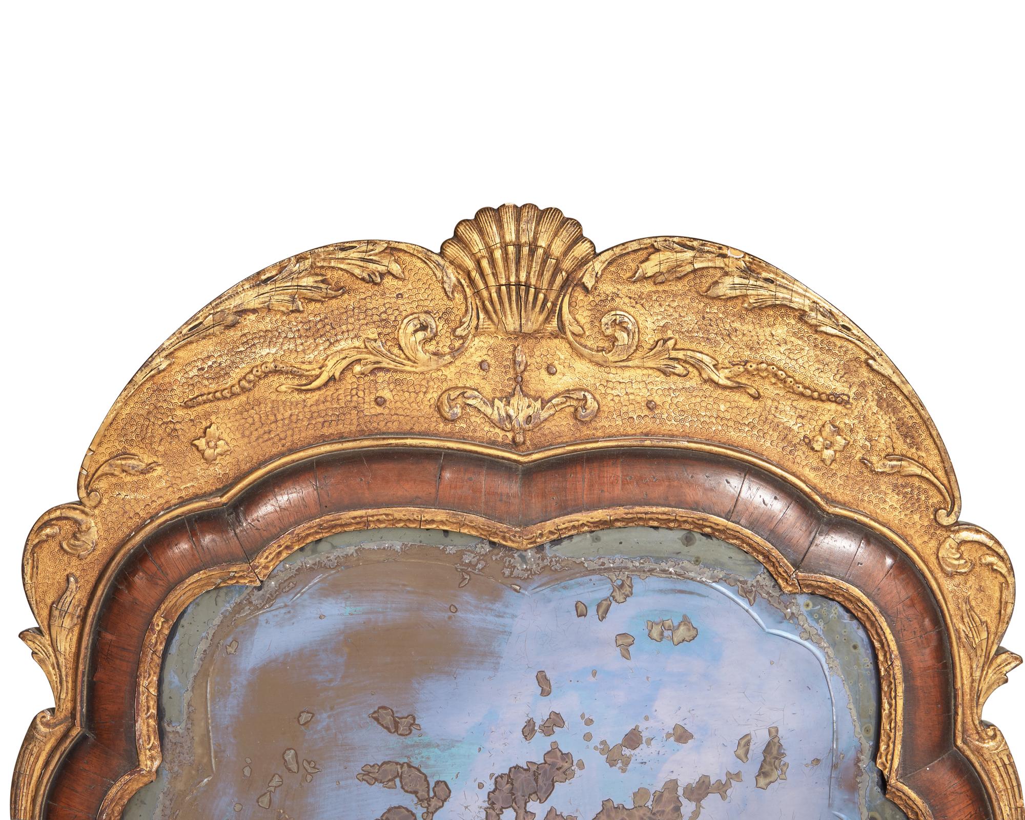 A pair of Queen Anne giltwood and walnut veneered pier glasses with etched mirror plates, 18th / 19th century