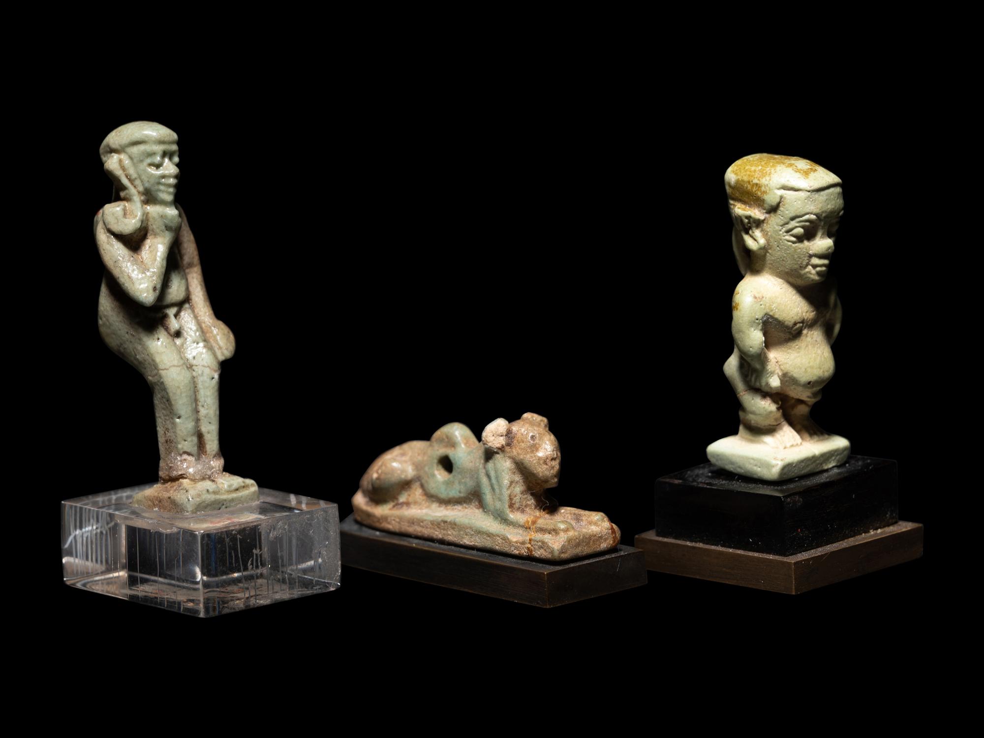Three Egyptian Faience Amulets Including a Pataikos, a Harpocrates, and a Recumbent Lion