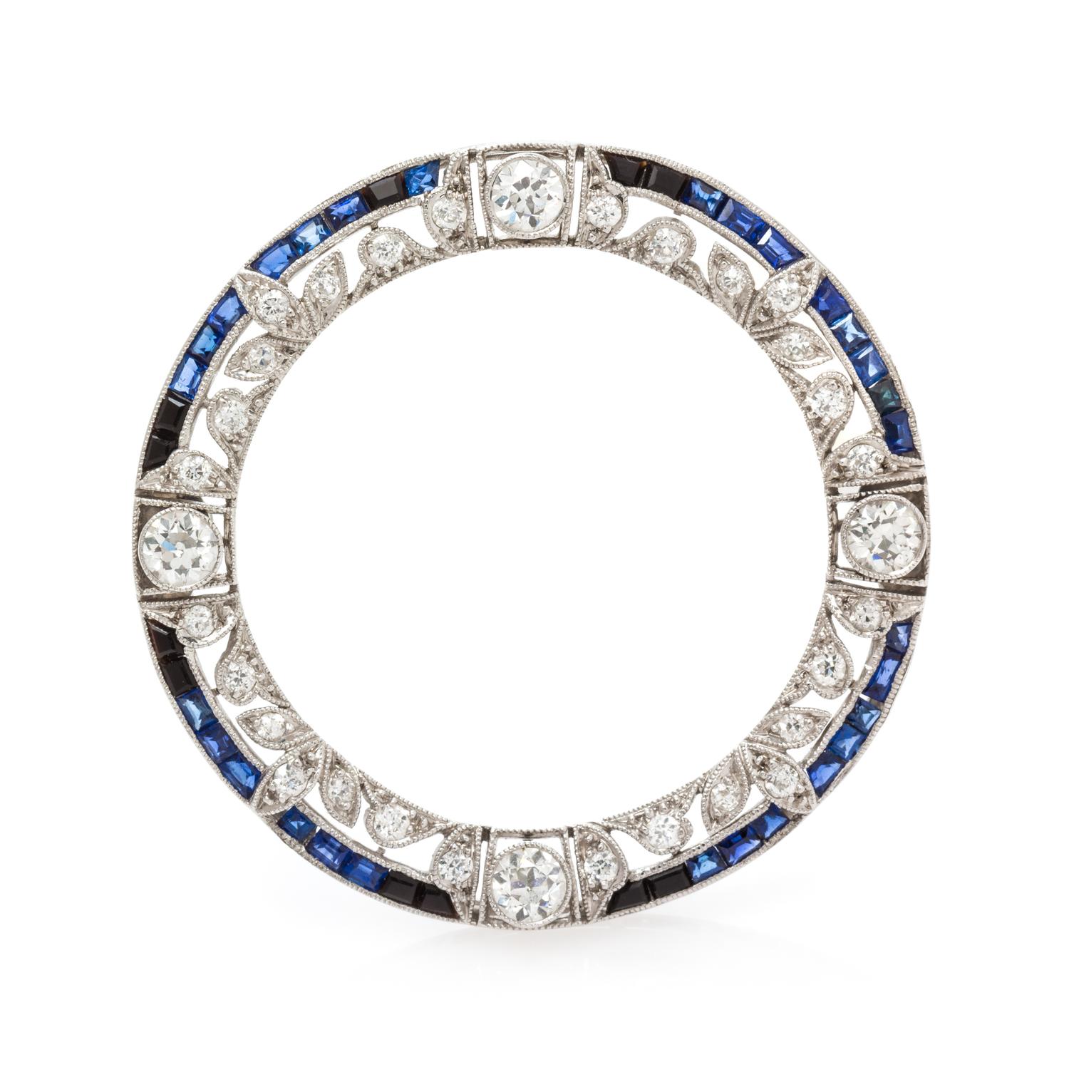 An Edwardian Platinum, Diamond, and Sapphire Circle Brooch, 5.65 dwts.