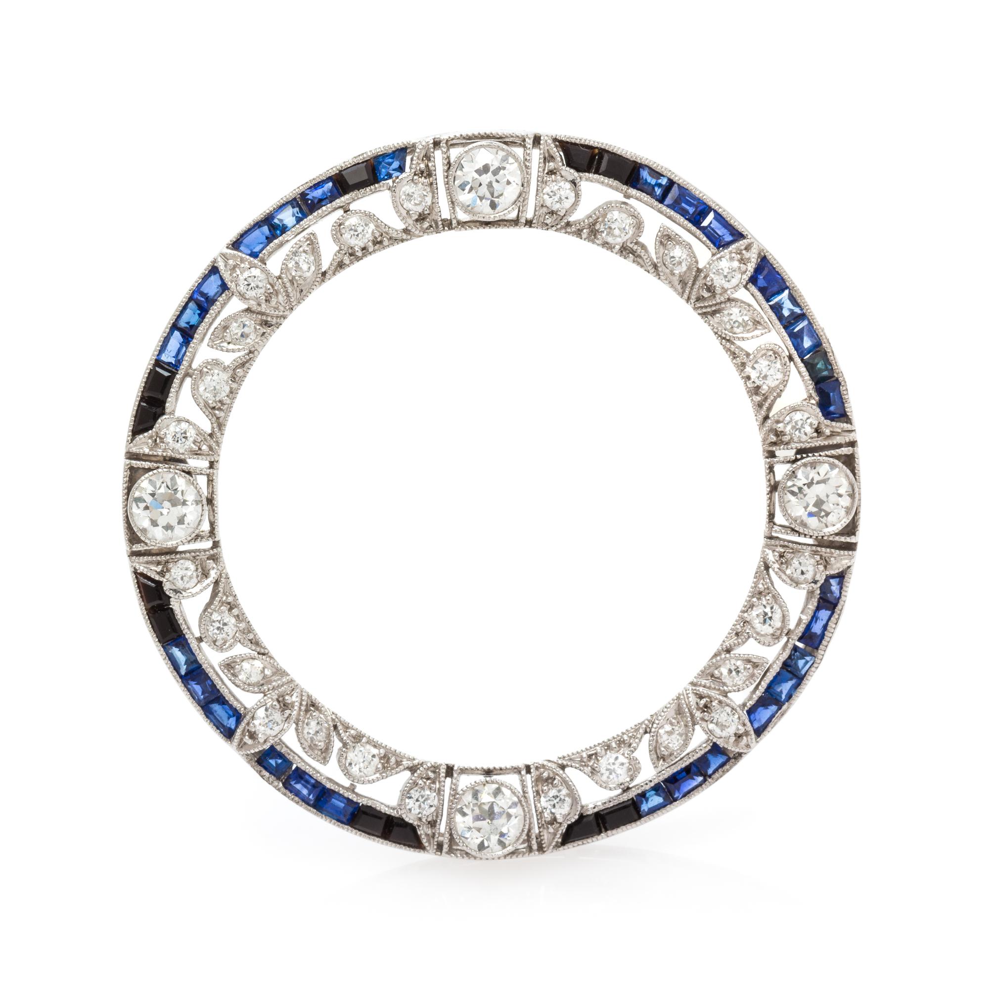An Edwardian Platinum, Diamond, and Sapphire Circle Brooch, 5.65 dwts.