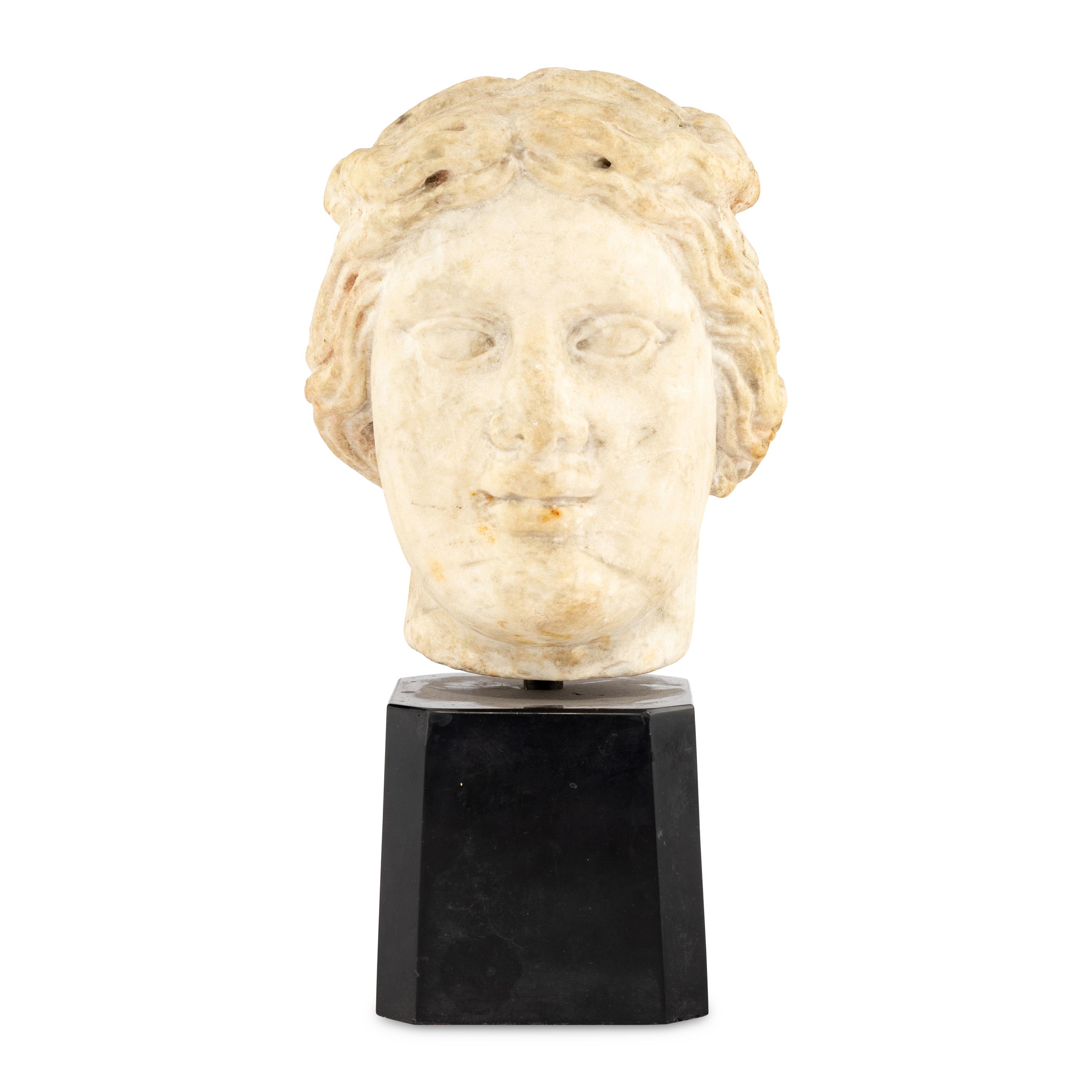 A Continental Carved Marble Head of a Woman