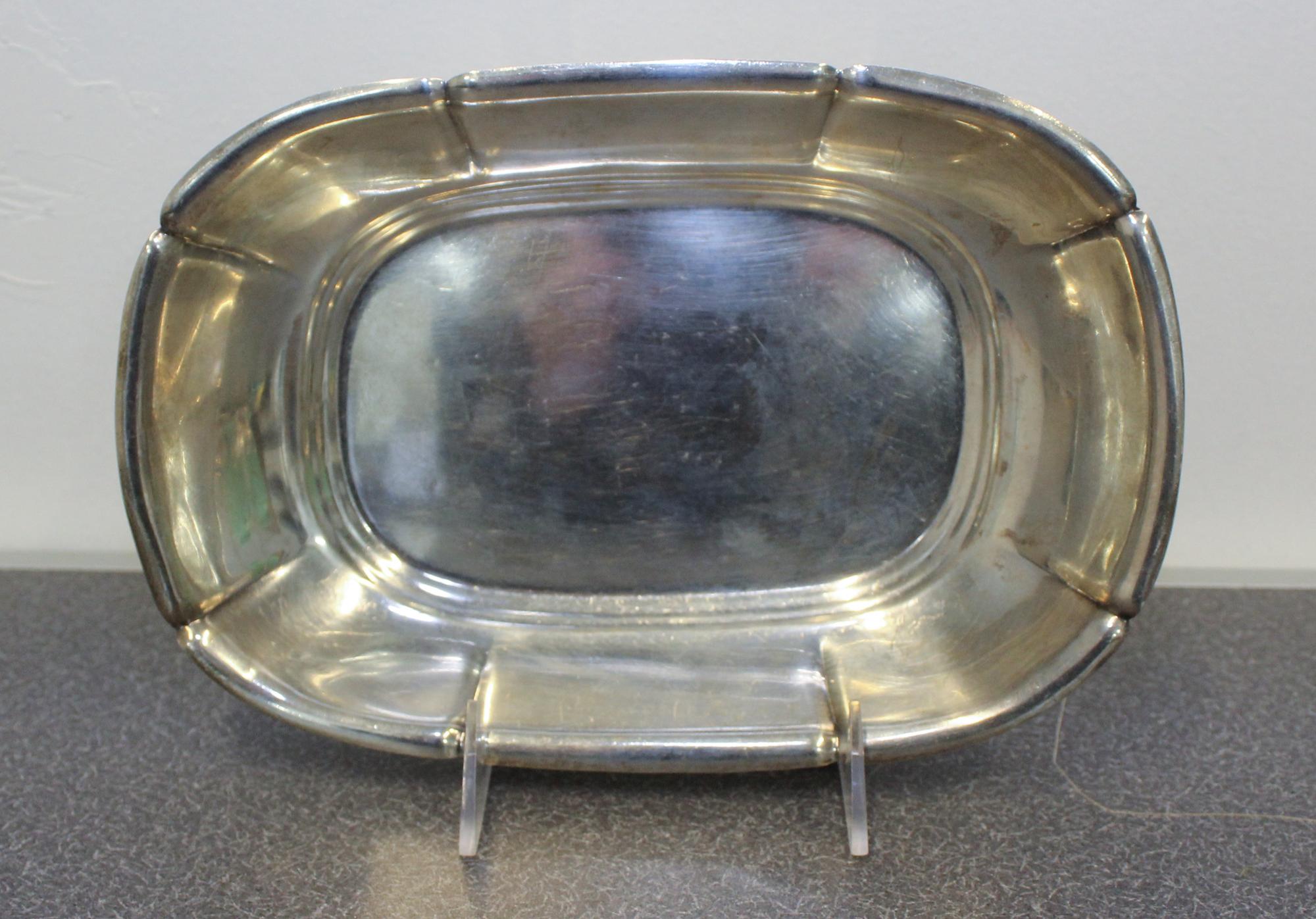 An American Silver Dish, Reed & Barton, Taunton, MA, having an undulating rim with a fluted body and banded base.