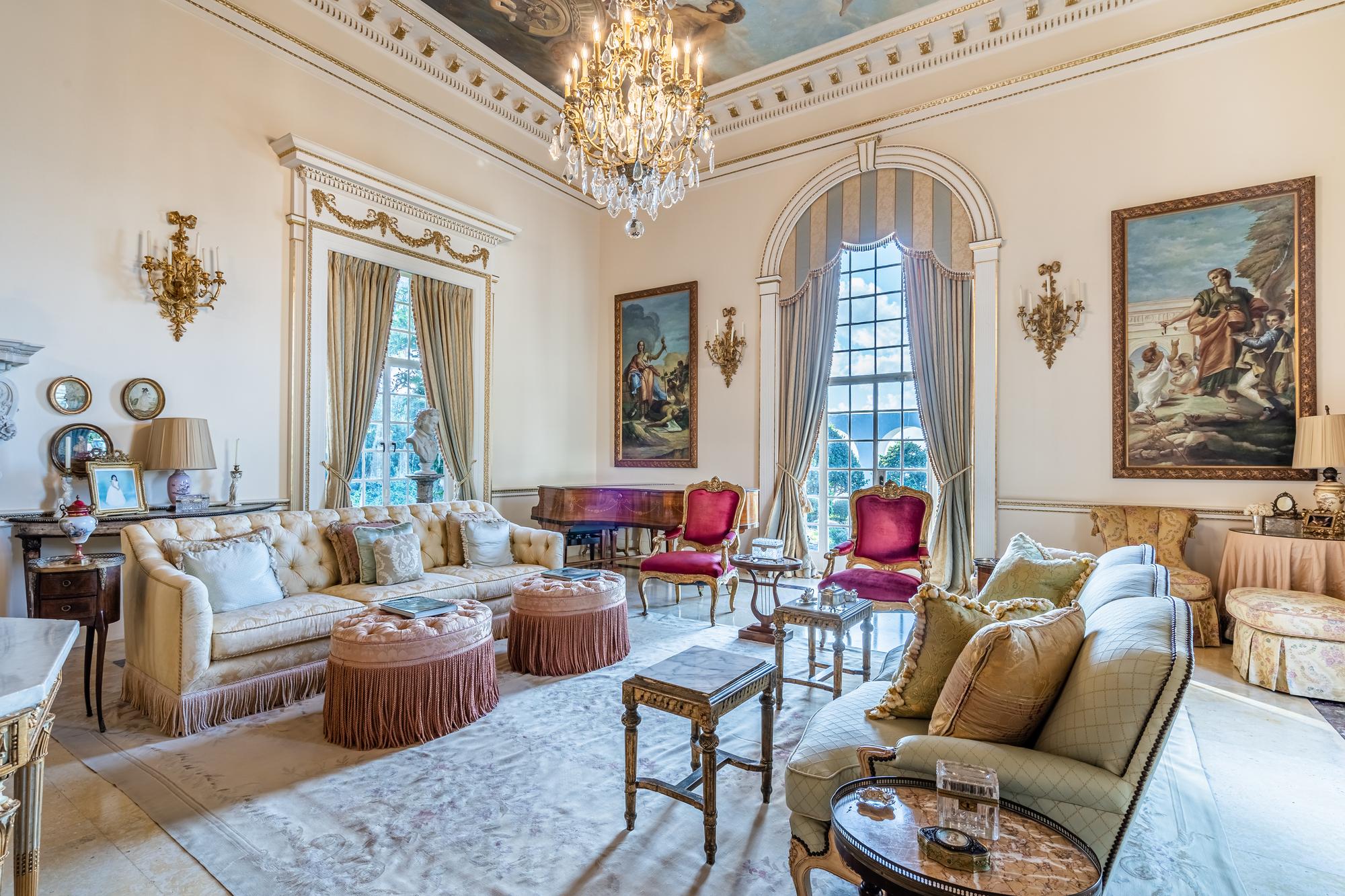 A Pair of Button-Tufted Damask Upholstered Ottomans