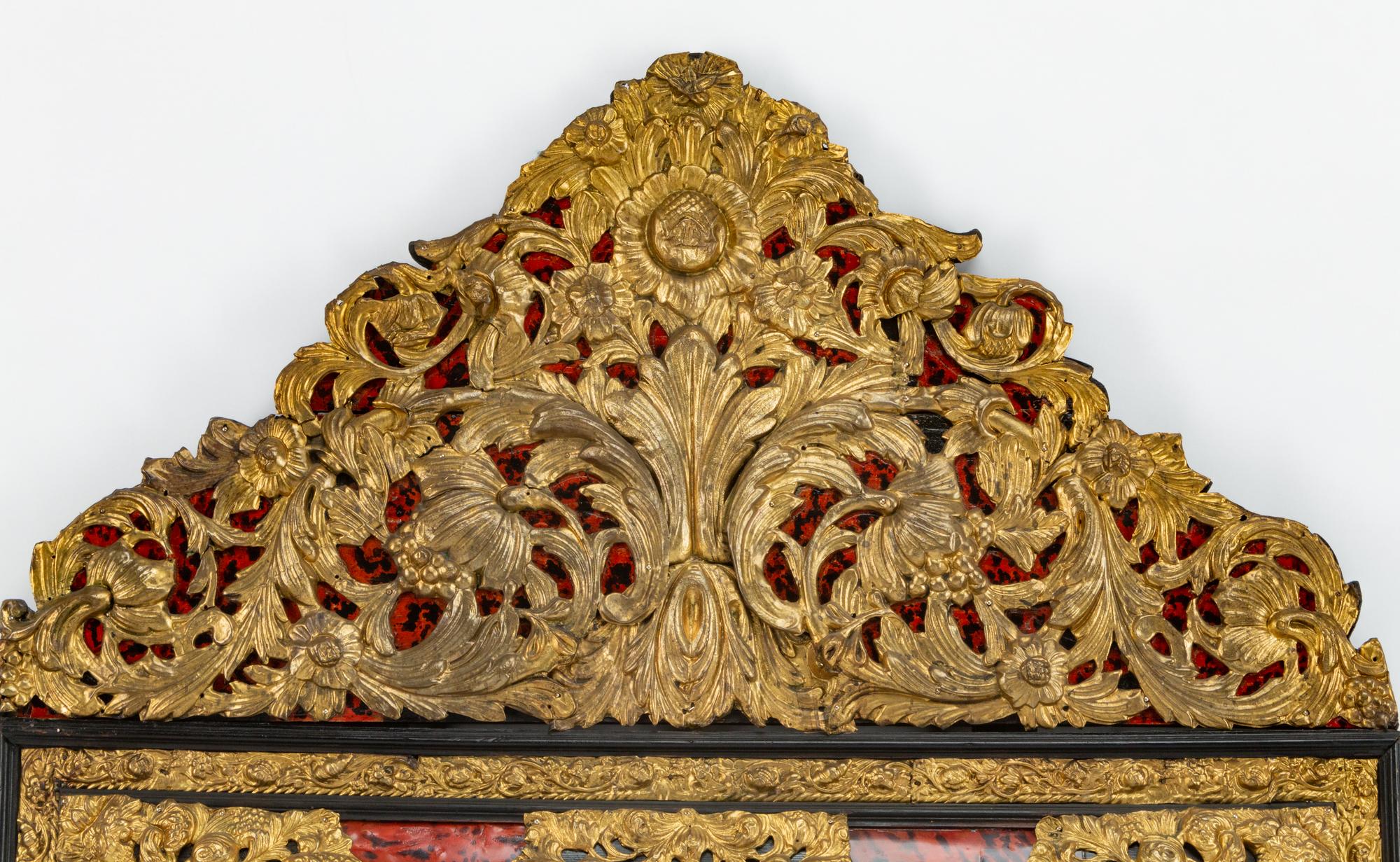A Flemish Baroque Style Repouséed Brass, Simulated Tortoise and Ebonized Wood Mirror