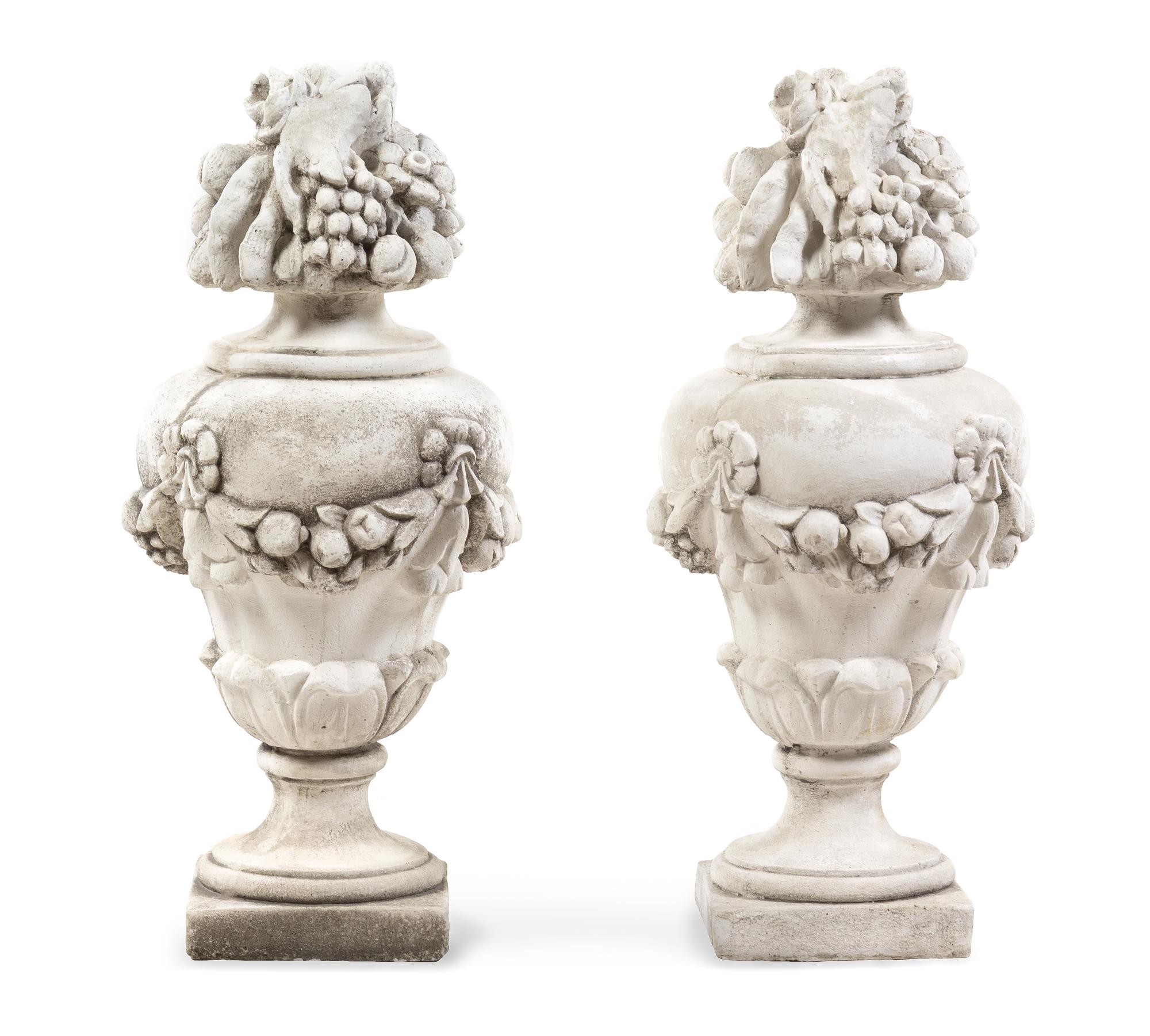 A Pair of Cast Stone Models of Fruit-Filled Urns Height 31 inches. — 20TH CENTURY