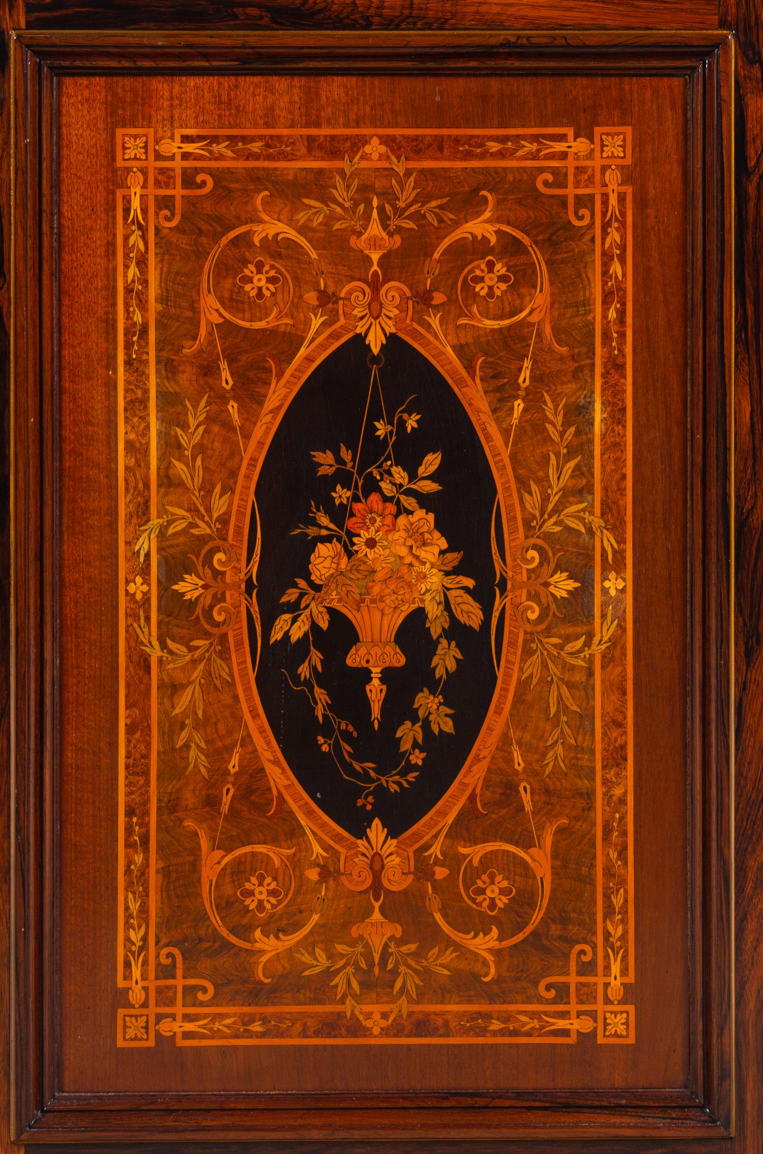 A Victorian Parcel Gilt, Ebonized and Inlaid Rosewood Parlor Cabinet