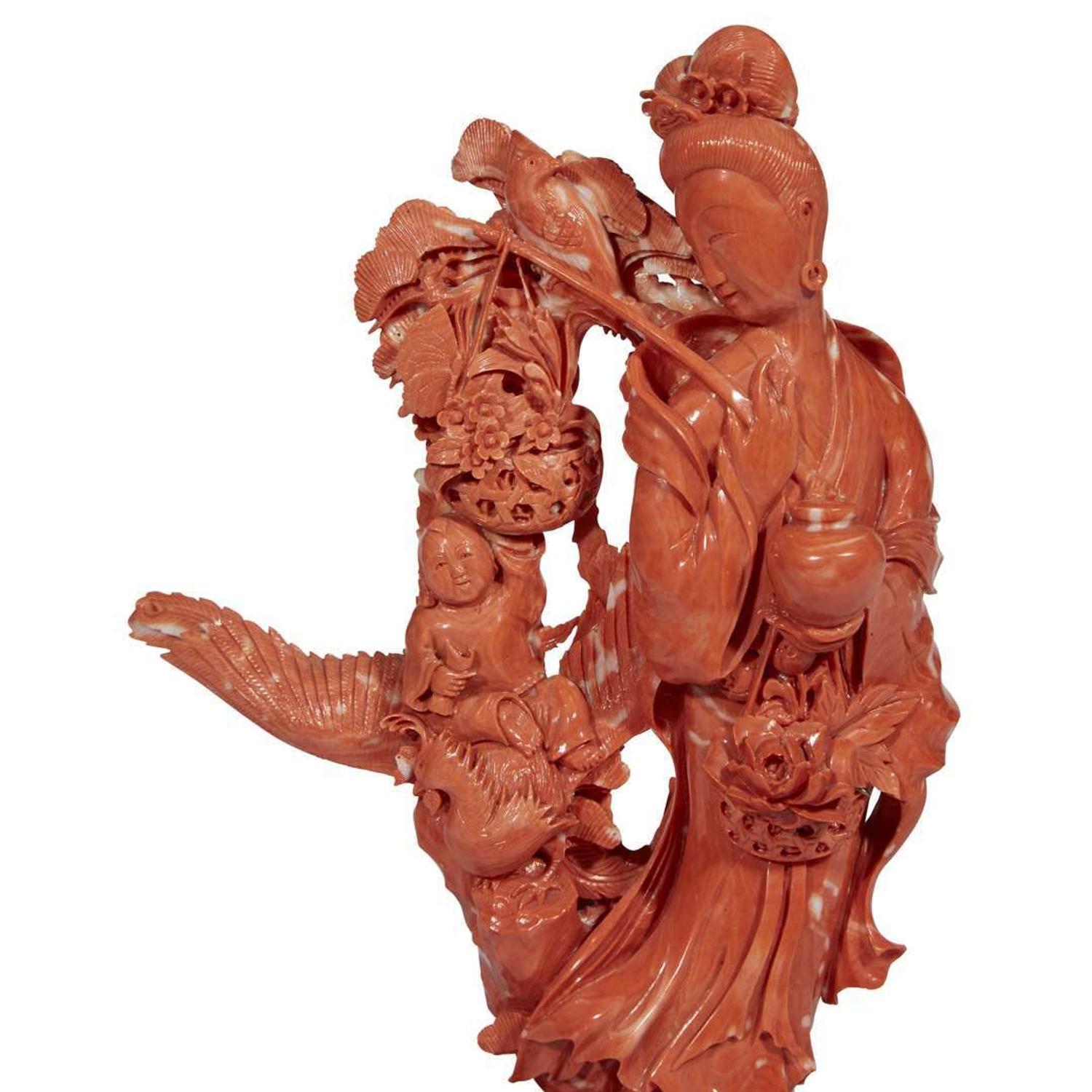 A Japanese carved red coral figure of an Immortal with basket of flowers and a boy on Ho-o bird