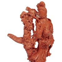 A Japanese carved red coral figure of an Immortal with basket of flowers and a boy on Ho-o bird