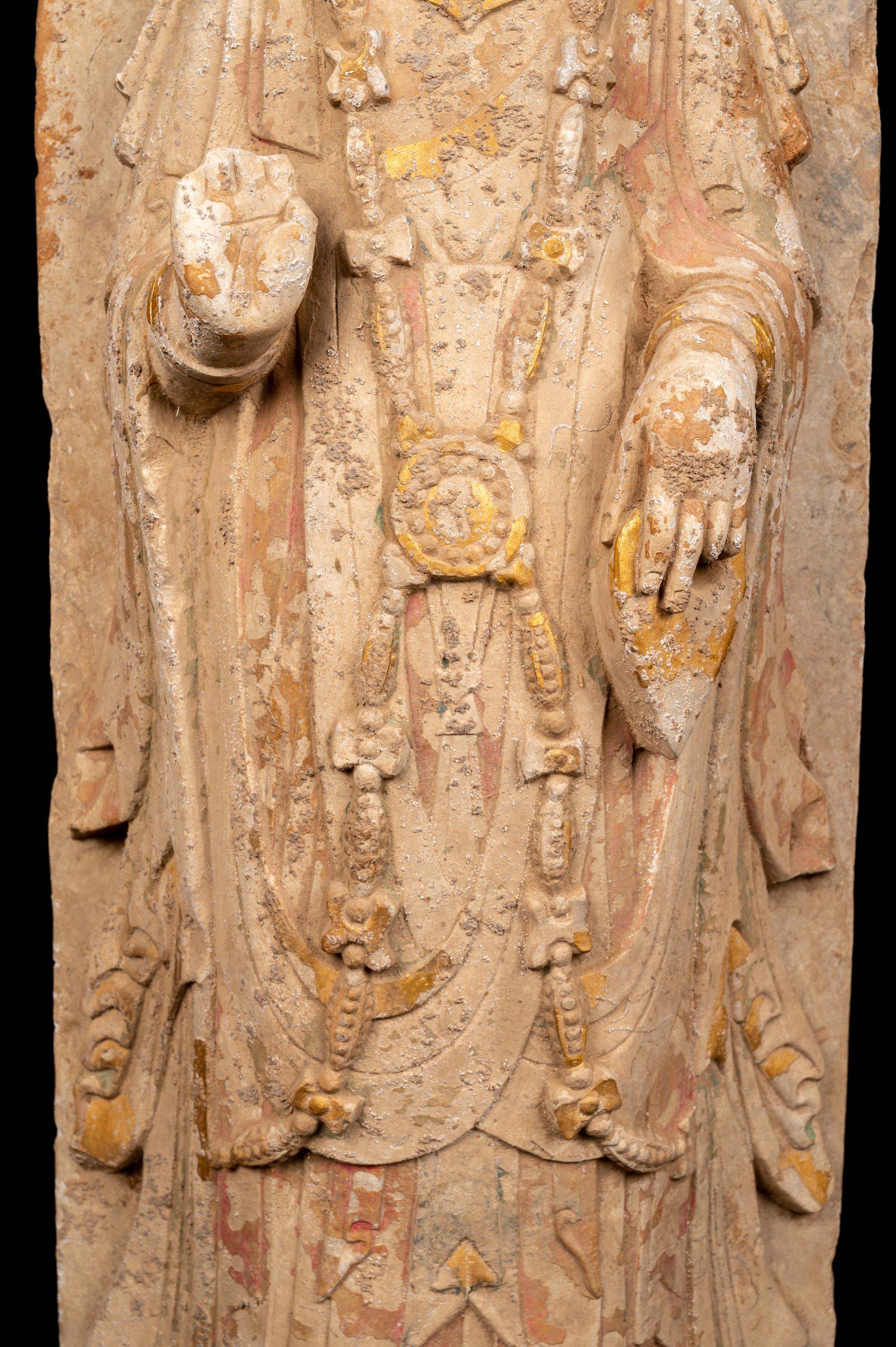 A Chinese Carved Stone Standing Buddha with Remnants of Gilt on Lotus-Form Base