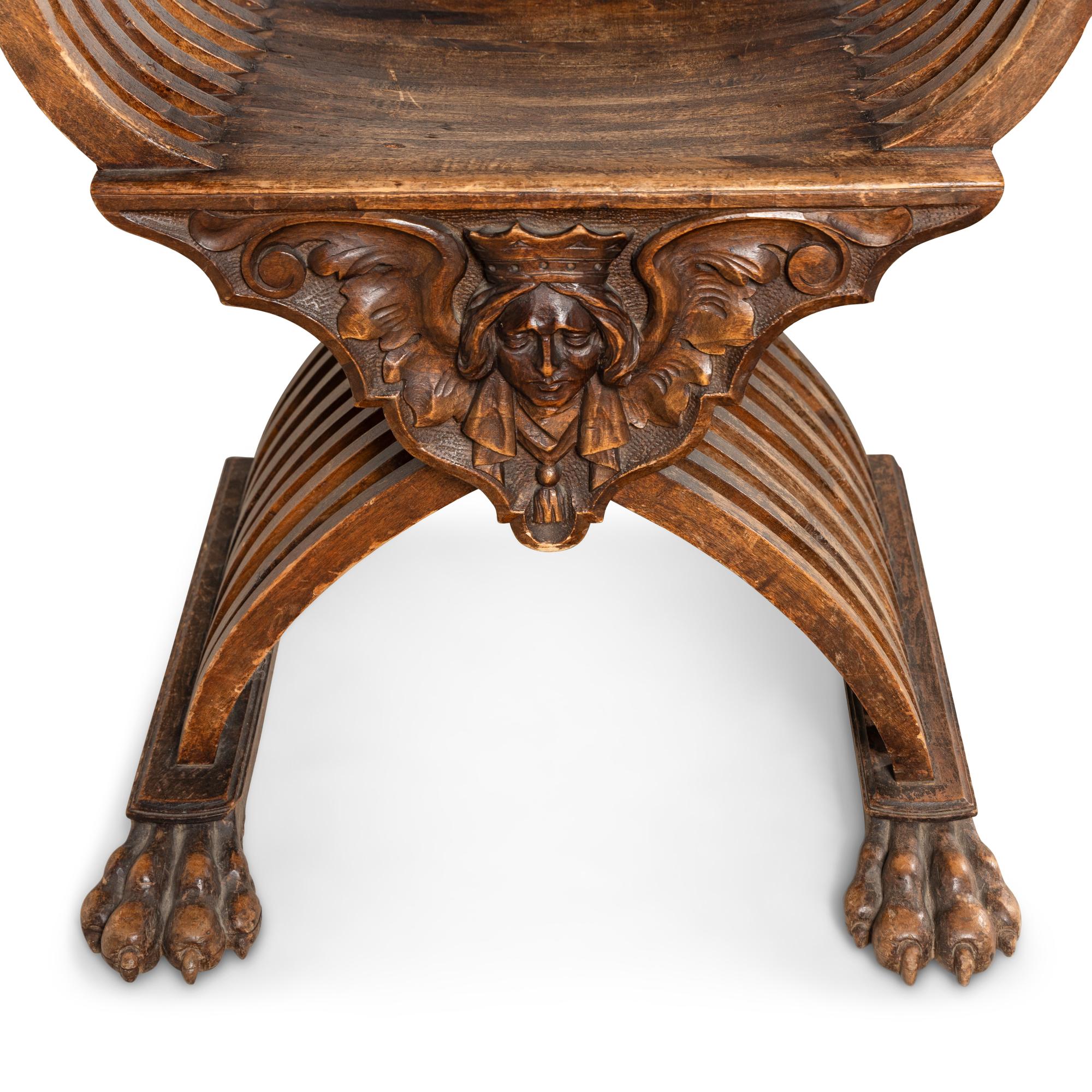 A Pair of Italian Carved Walnut Savonarola Chairs