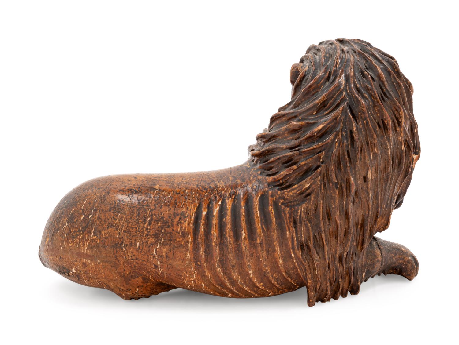 A Carved Wood Figure of a Lion
