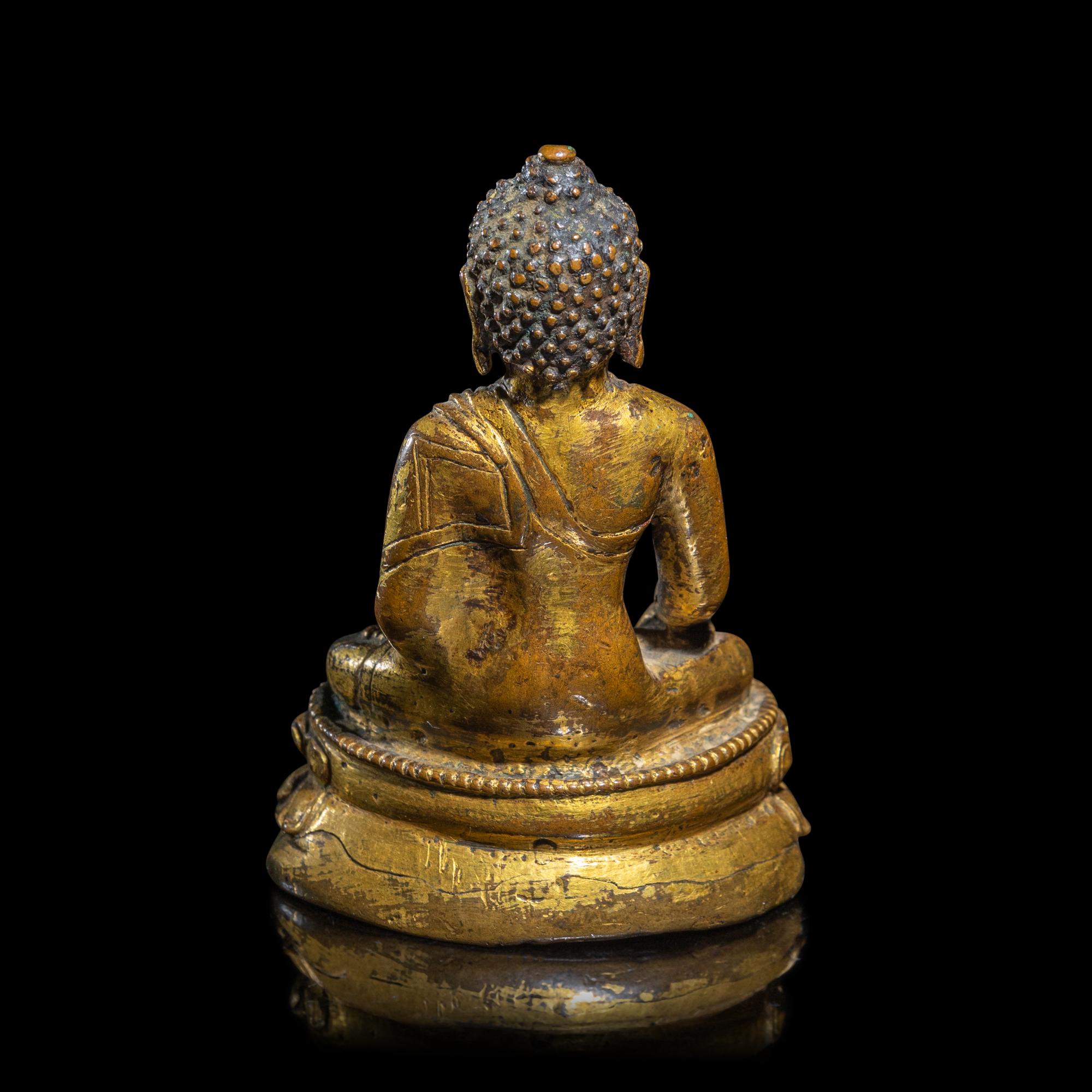 A Tibetan Gilt Copper Alloy Figure of Buddha Shakyamuni, 15th/16th Century 十五/十六世紀 西藏銅鎏金坐佛
