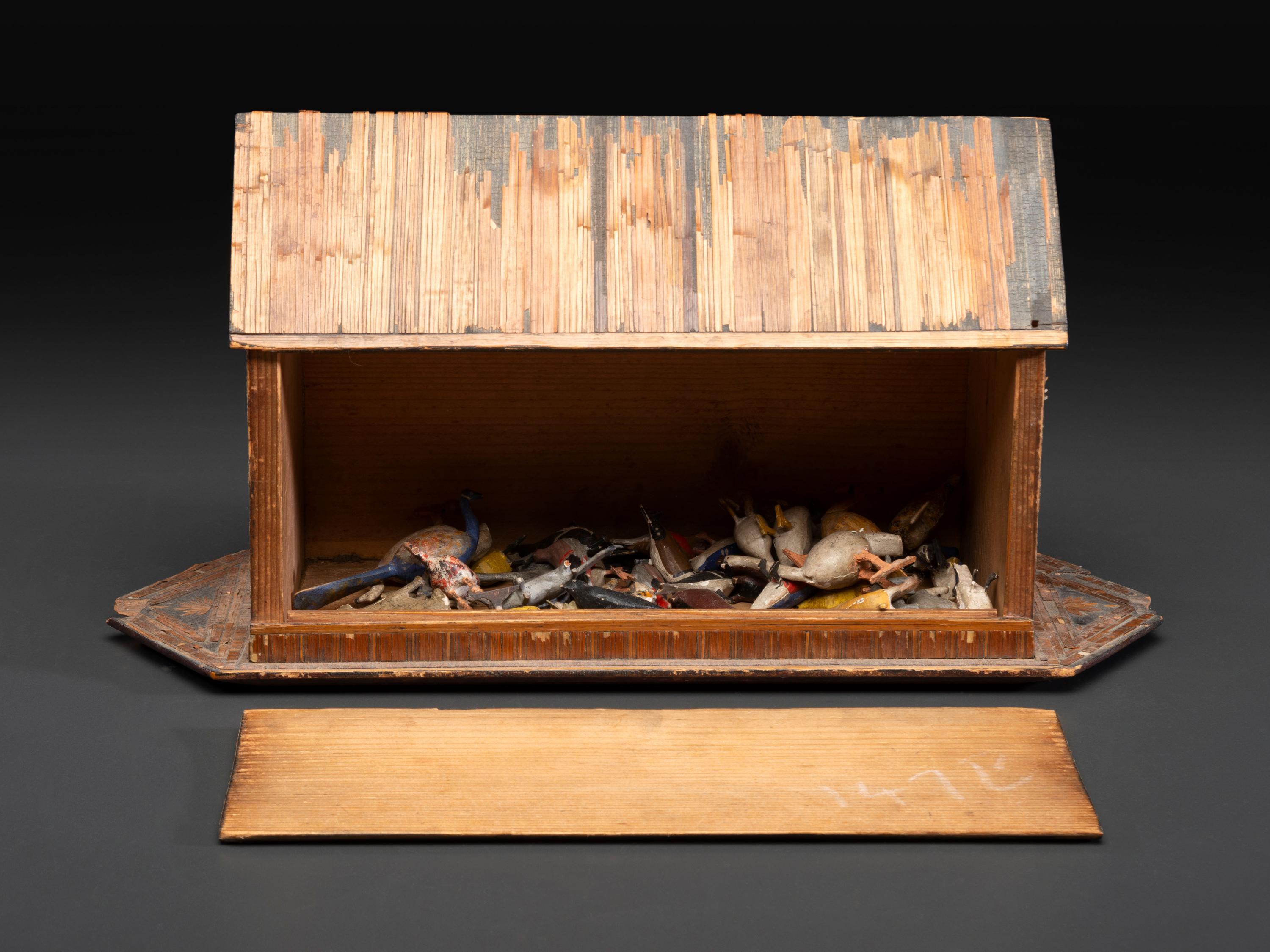 A Carved Wood and Applied Straw Work Noah's Ark with Slide-Front Cover