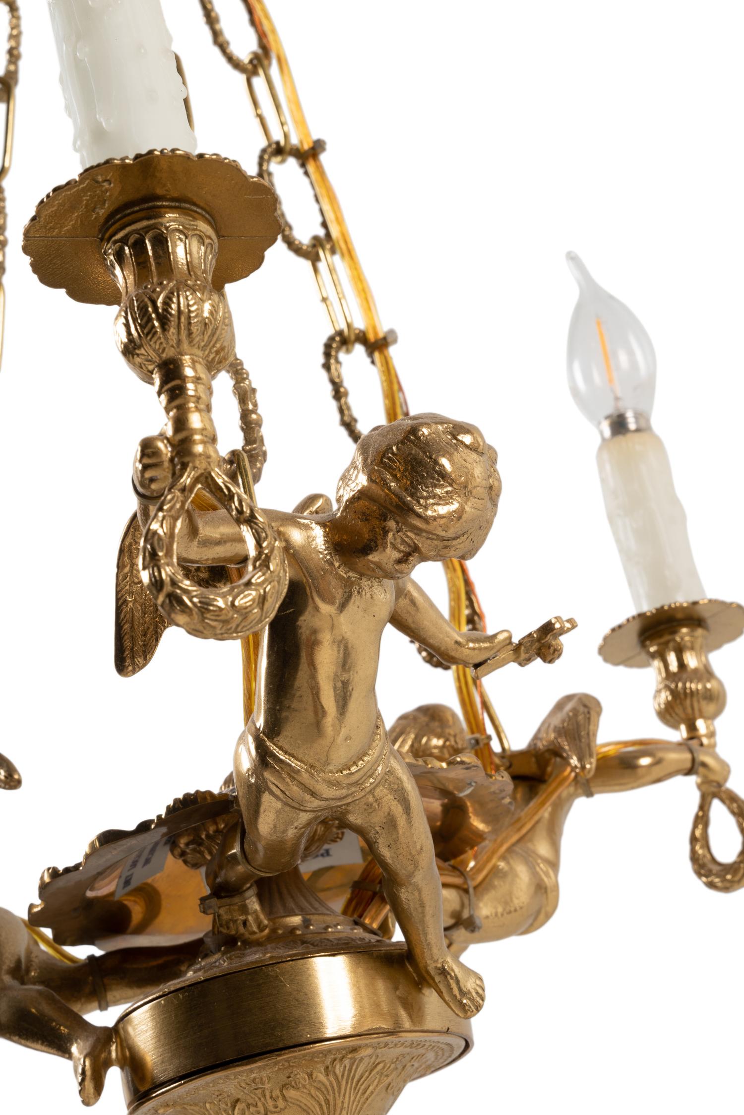 A Continental Gilt Metal Figural Three-Light Chandelier