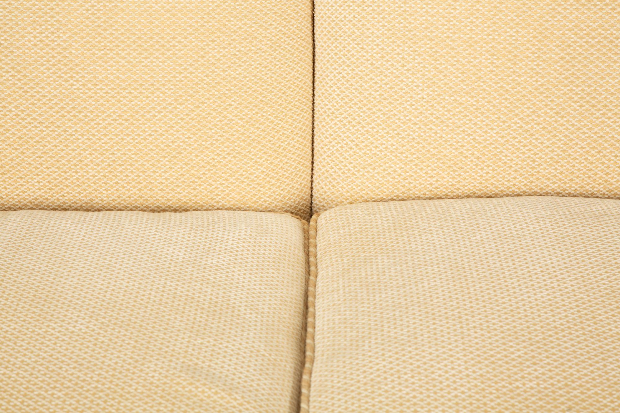 A Pair of Ivory Upholstered Three Cushion Sofas — 20th Century