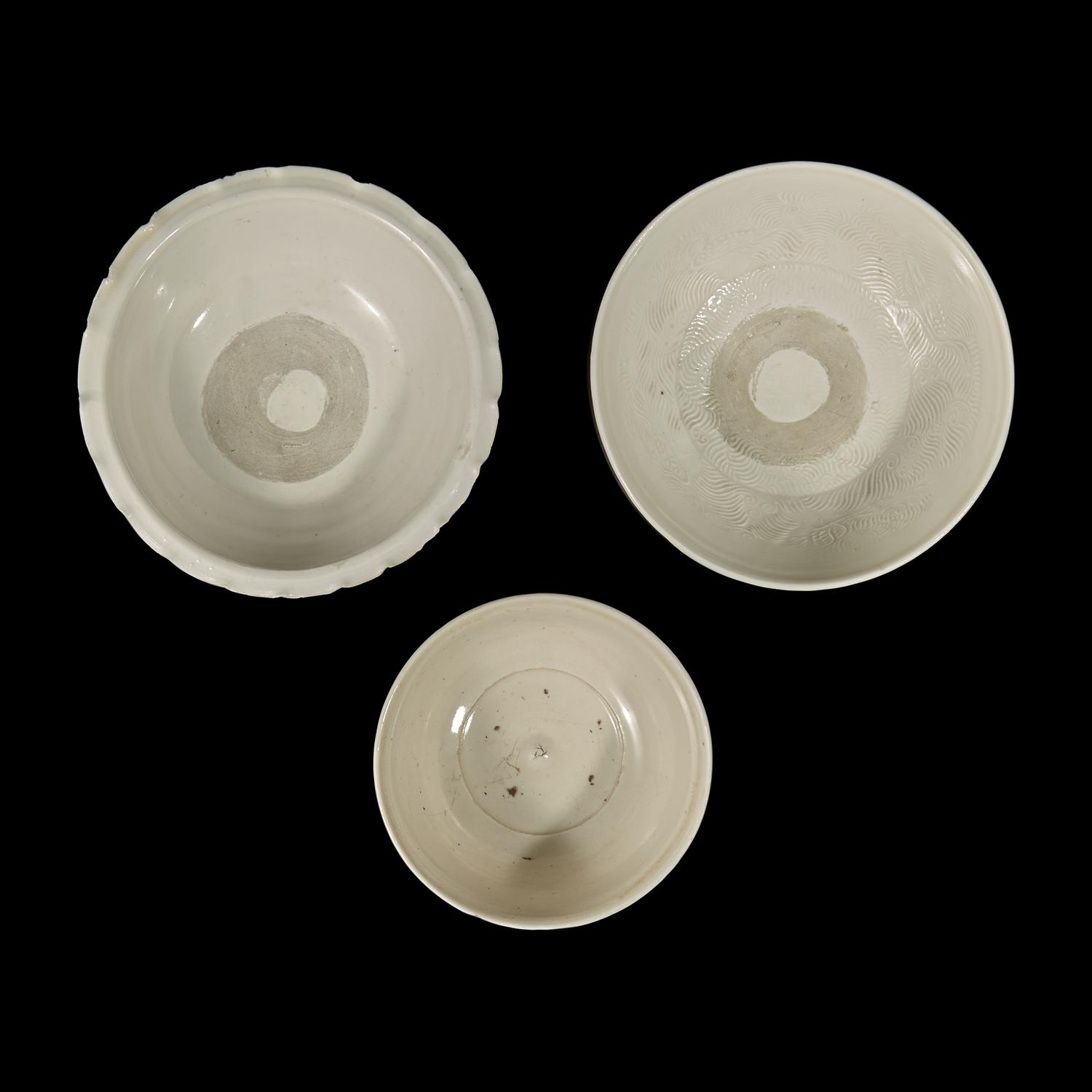 Two Chinese Huozhou White Glazed Bowls and a Stem Cup, Song Dynasty 宋 霍州窯白釉瓷碗二及高足杯一