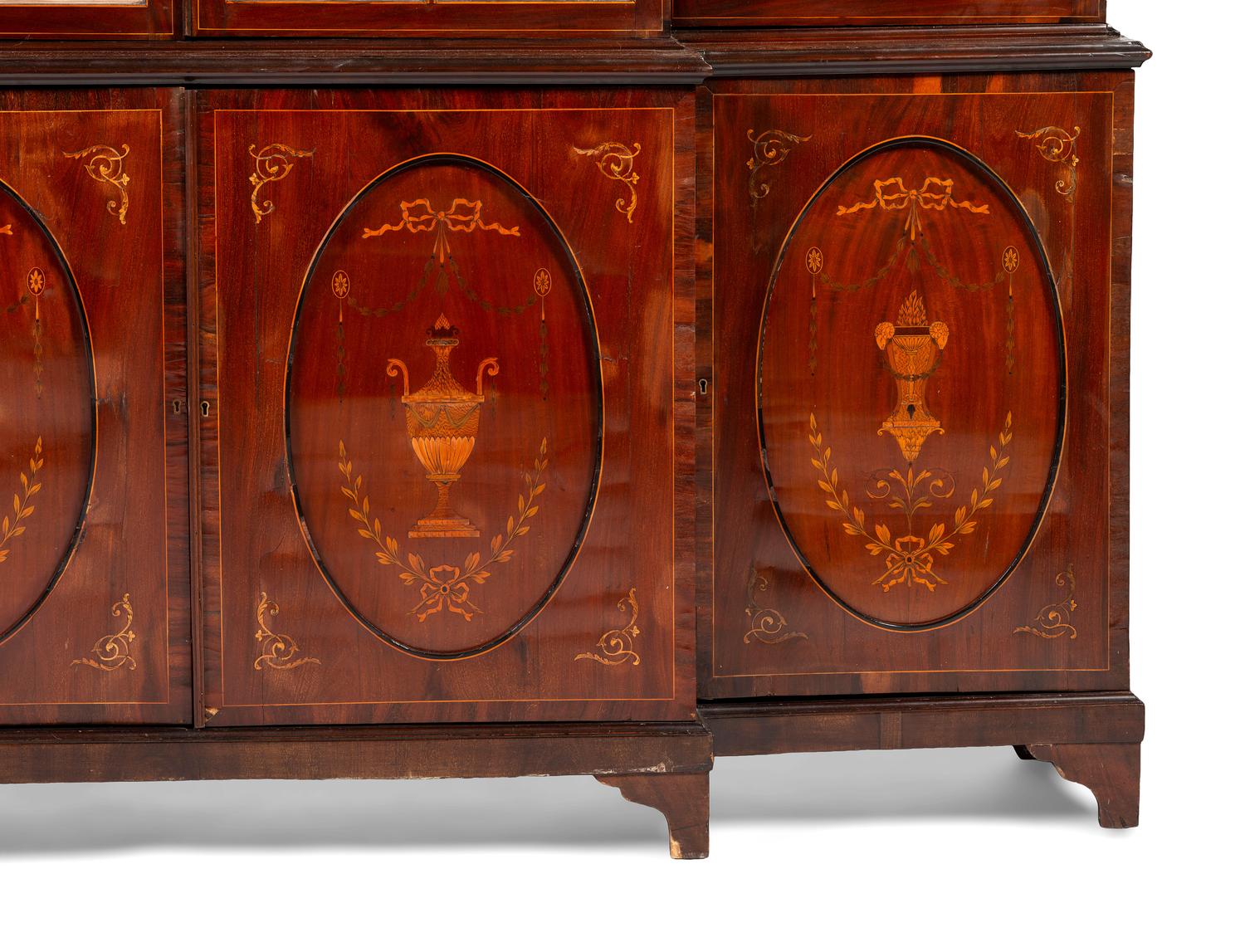 An English Mahogany and Marquetry Breakfront Bookcase